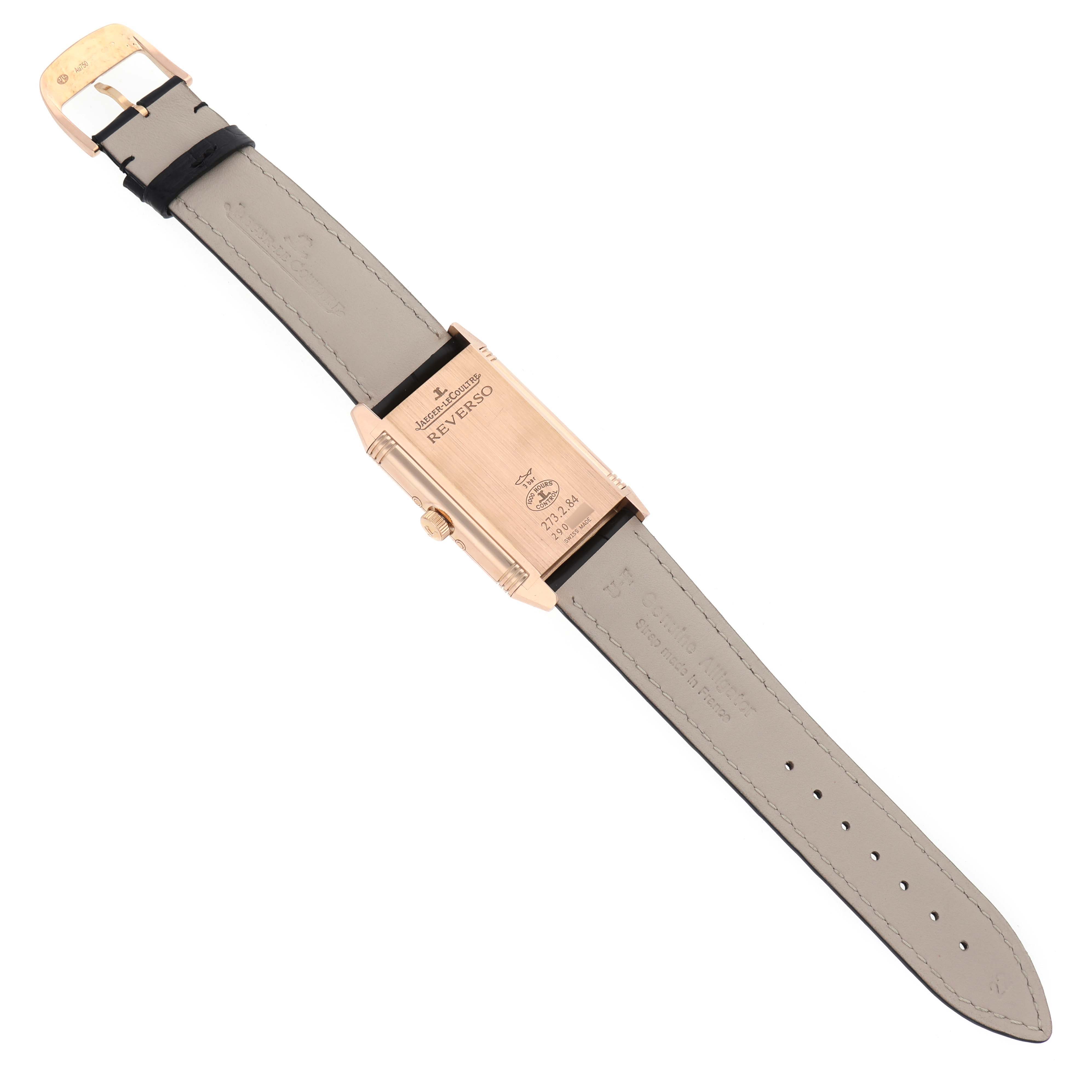 The Jaeger-LeCoultre Reverso watch is shown from the back, displaying its strap and caseback details.