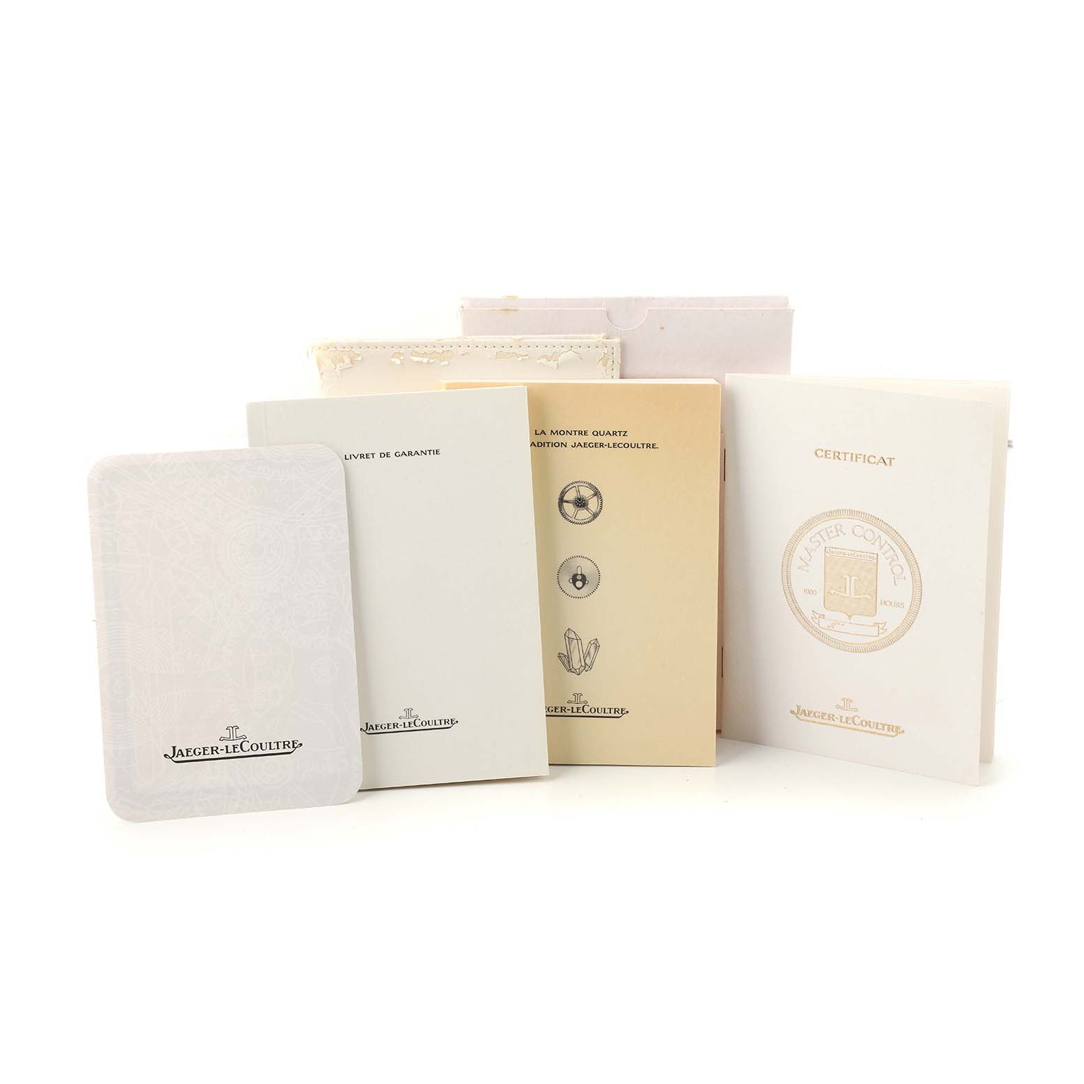 The image shows documents and booklets related to the Jaeger-LeCoultre Master model, including warranty and certification papers.