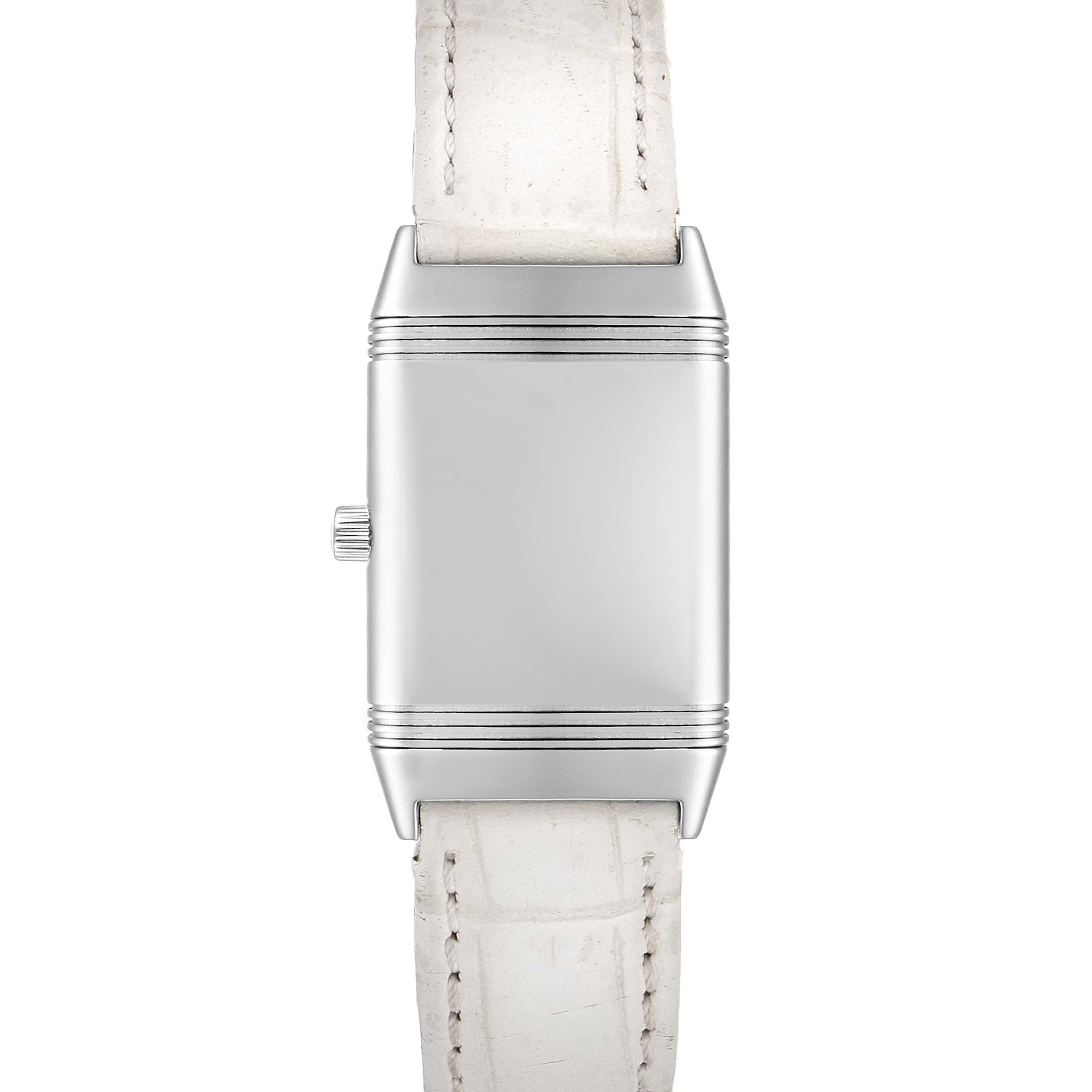 The image shows a front angle of the Jaeger-LeCoultre Reverso watch with a white leather strap and a blank silver case.