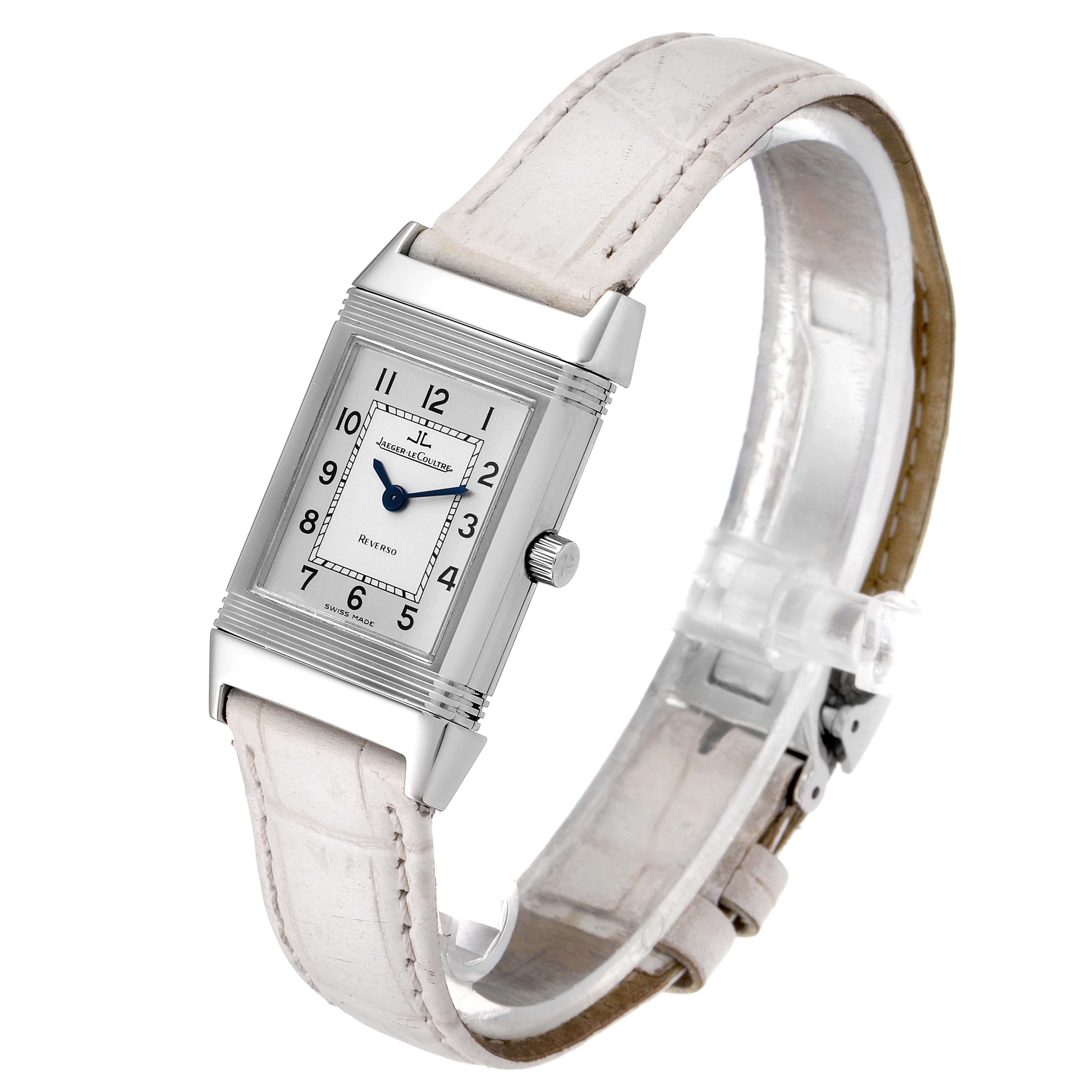 The Jaeger LeCoultre Reverso 260.8.08 Women
s Stainless Steel Silver Dial 260.8.08 Women
s Stainless Steel Silver Dial watch is shown at a three-quarter angle, highlighting its rectangular face, white strap, and crown.