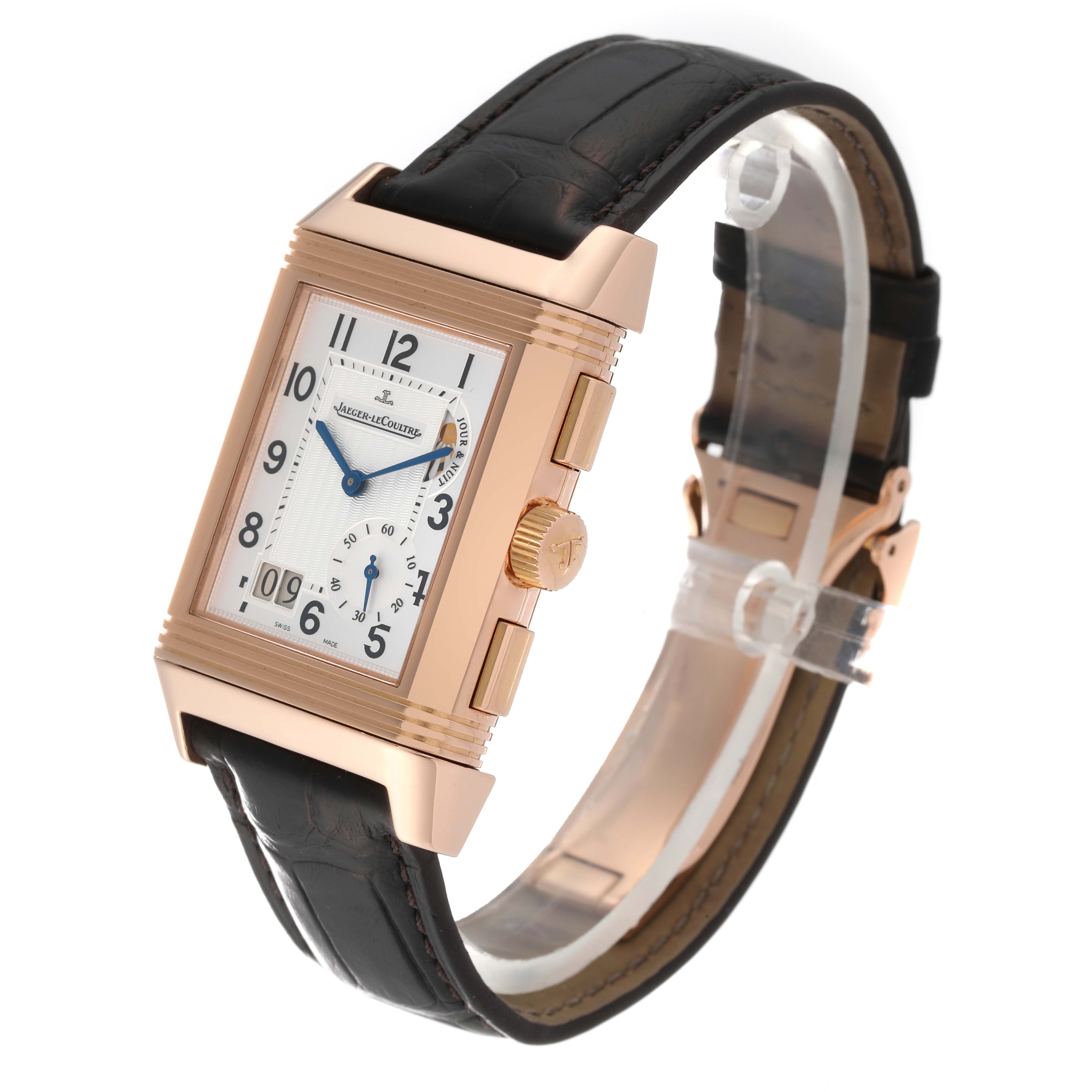The Jaeger LeCoultre Reverso Q3022420 Men's Rose Gold Silver Dial Q3022420 Men's Rose Gold Silver Dial watch is shown at an angle displaying its rectangular face, leather strap, and side buttons.