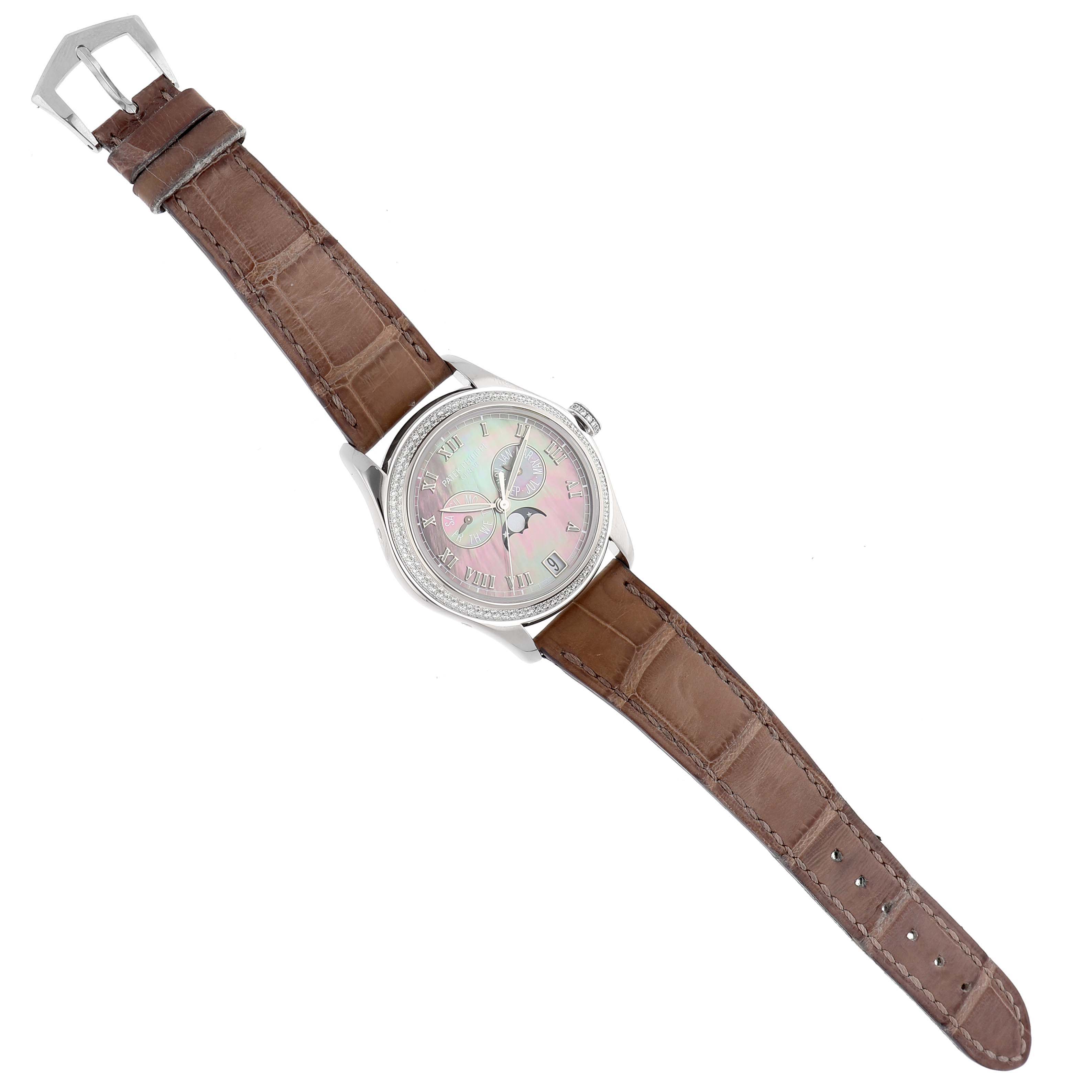 The Patek Philippe Complications 4936G - 001 Men's White Gold Mother of Pearl Dial watch is shown from a top-down angle, displaying its face, case, and leather strap.