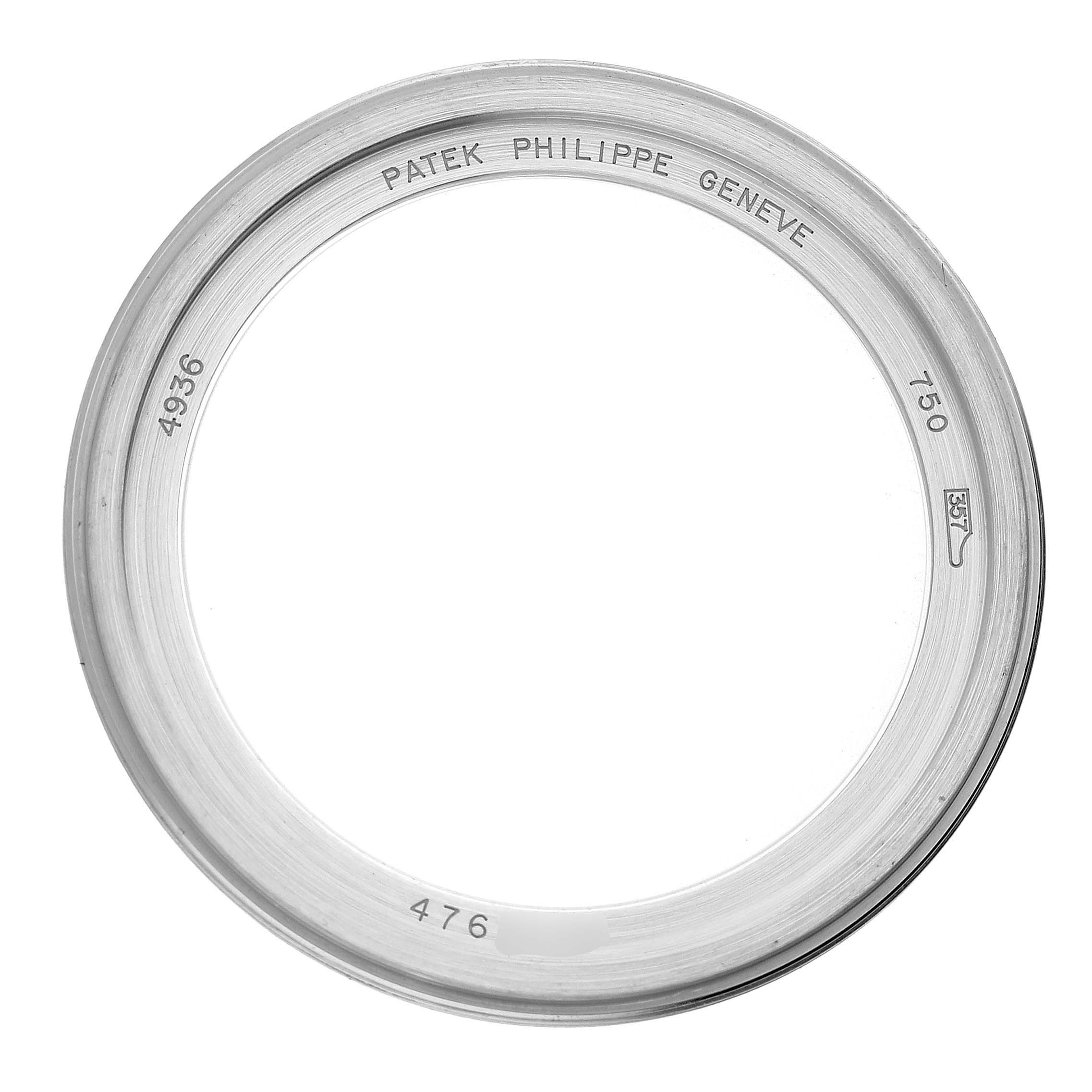 The image shows the bezel, a circular metal ring, from a Patek Philippe Complications 4936G - 001 Men's White Gold Mother of Pearl Dial model.