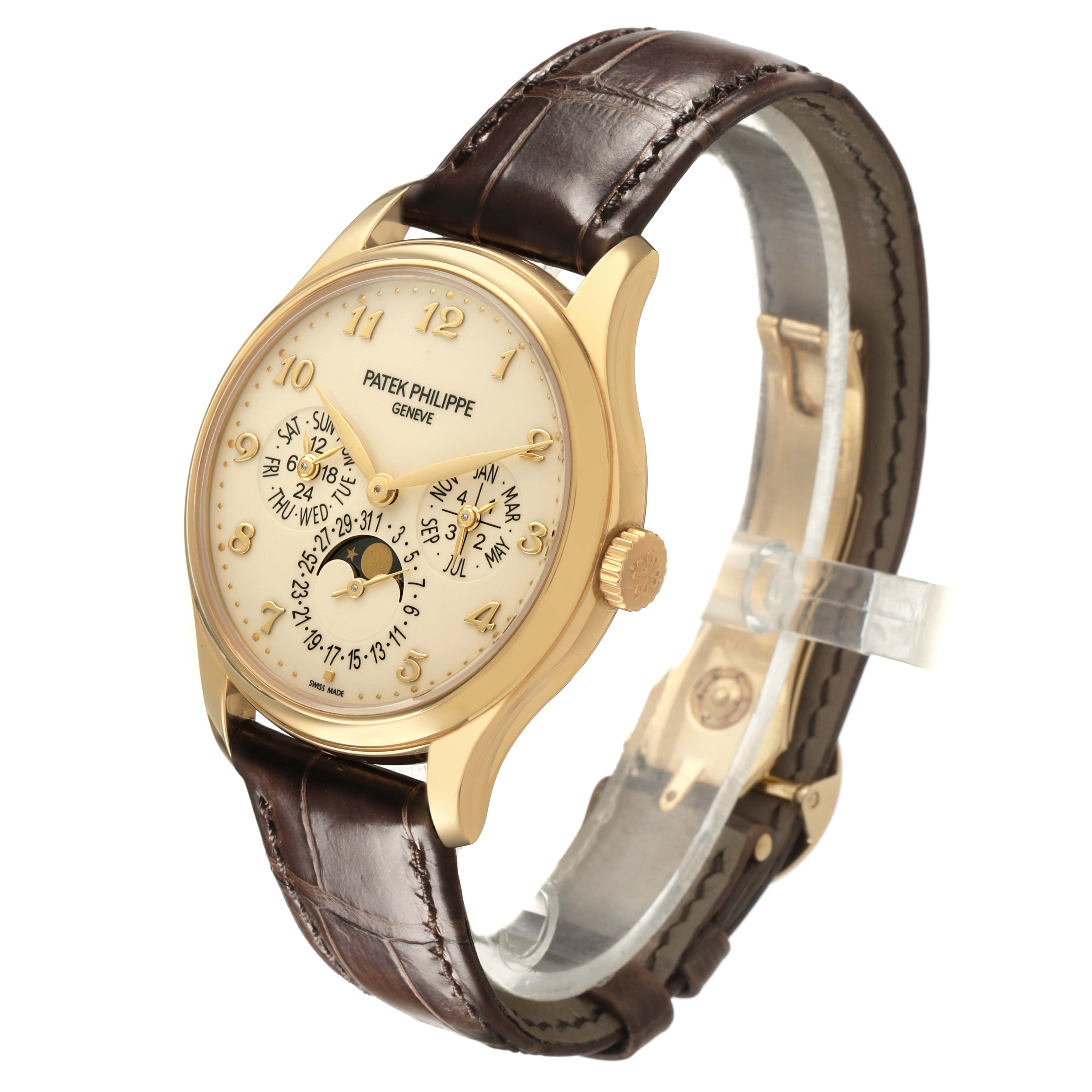 The Patek Philippe Complications 5327J-001 Men's Yellow Gold Beige Dial watch is shown at a three-quarter angle, highlighting its gold case, detailed dial, and brown leather strap.