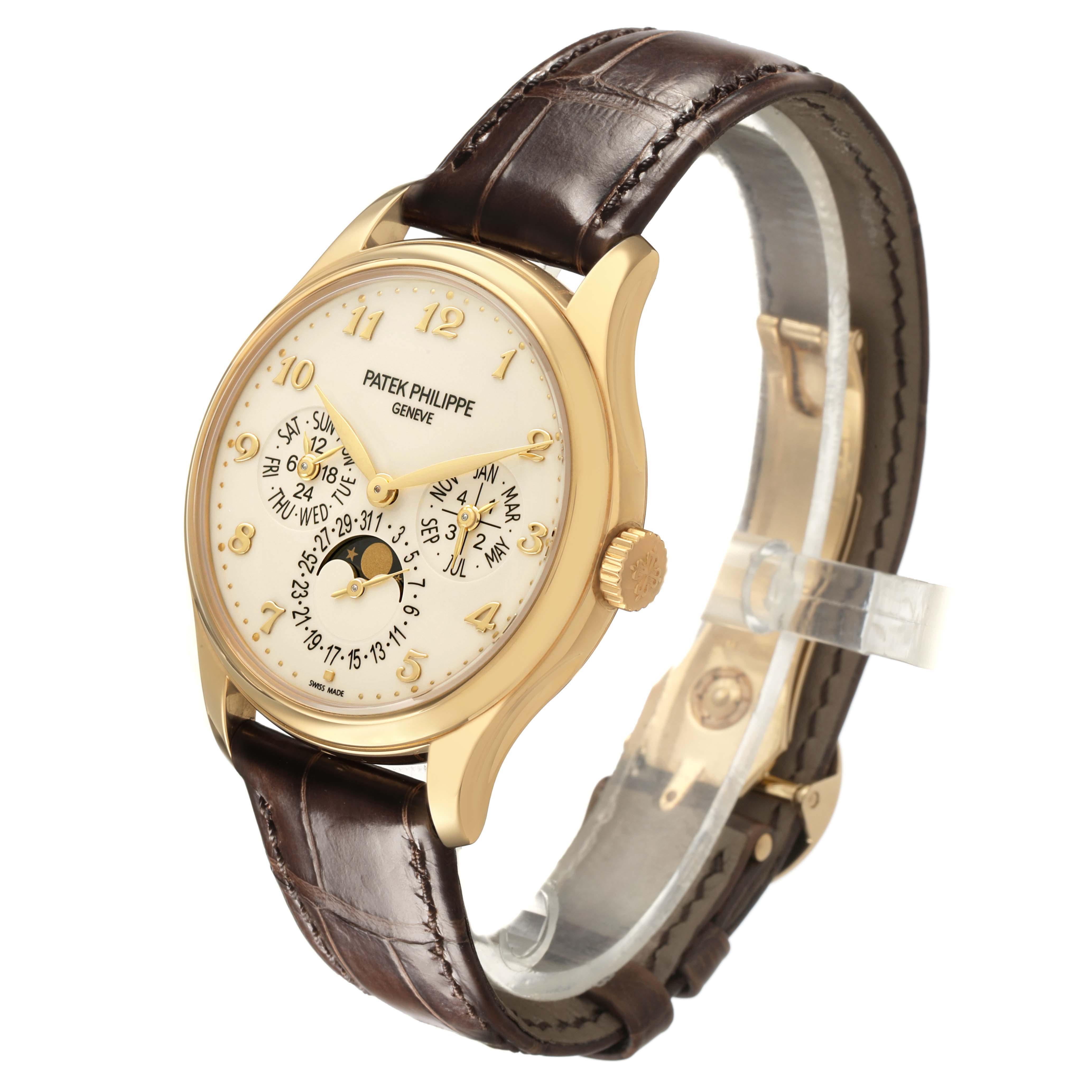 The Patek Philippe Complications 5327J-001 Men's Yellow Gold Beige Dial watch is shown from a three-quarter angle, displaying the dial, case, and strap clearly.