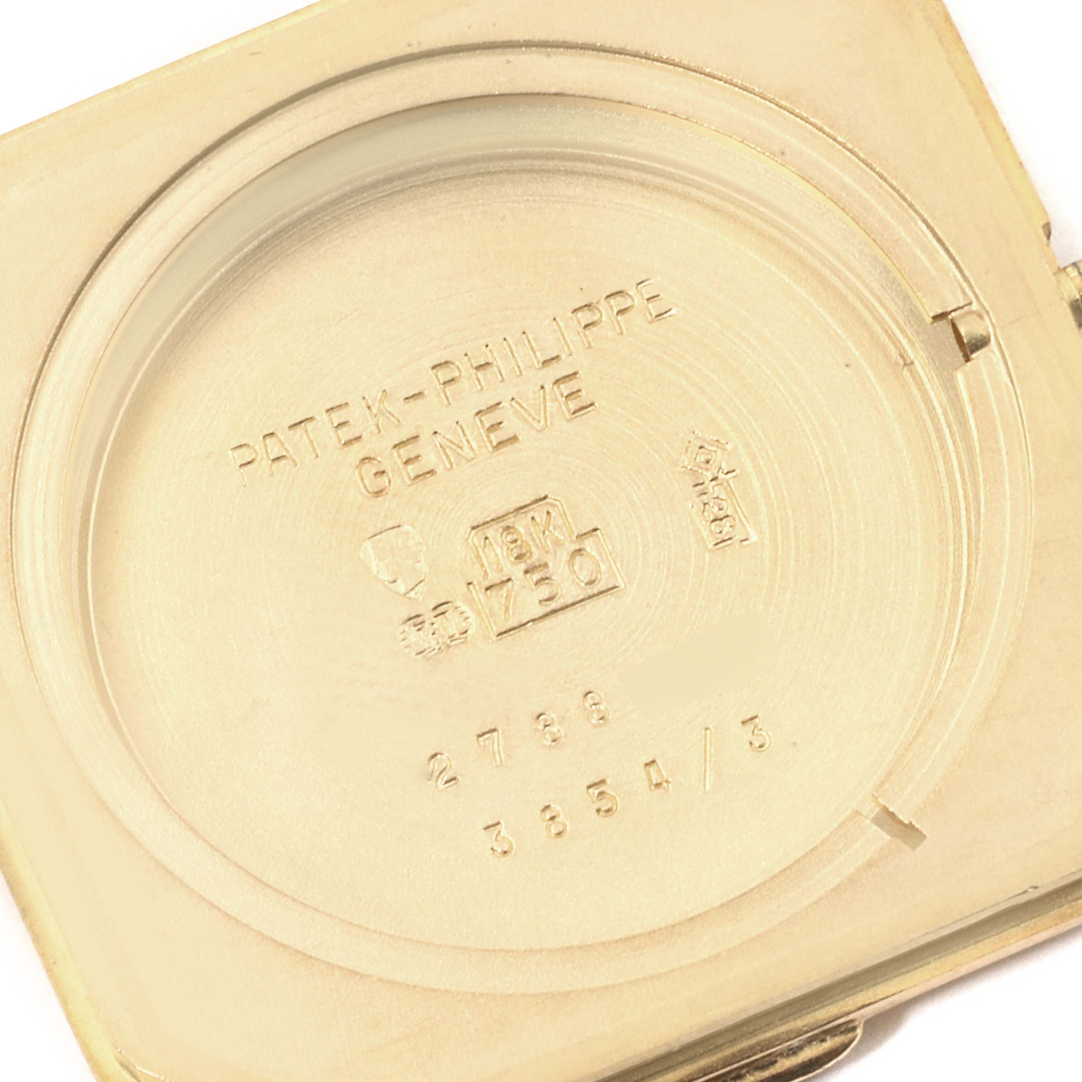 This image shows the inner case back of a Vintage Patek Philippe watch, revealing various engravings and hallmarks.