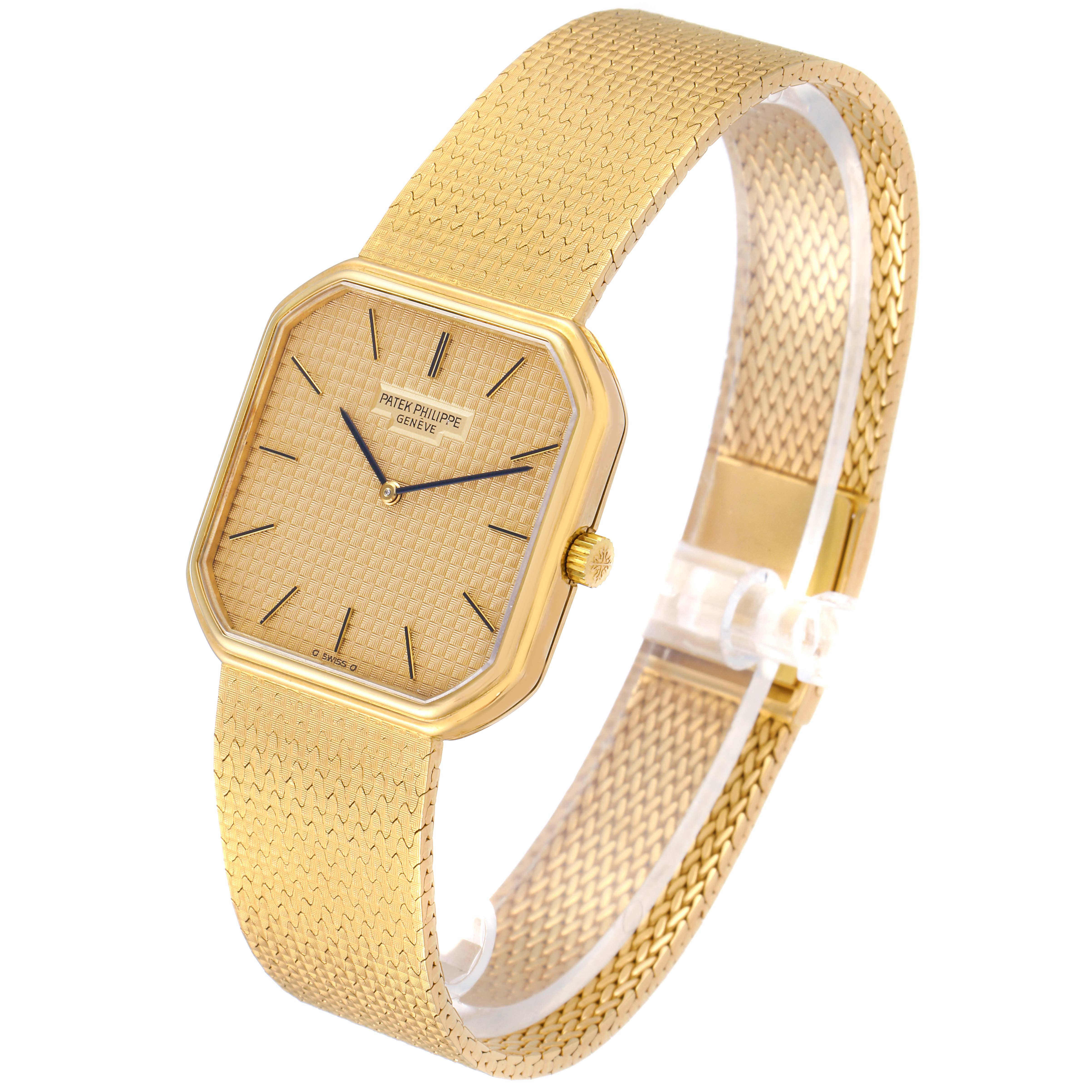 The image shows a side angle of a Vintage Patek Philippe watch, highlighting its gold mesh band and rectangular dial.