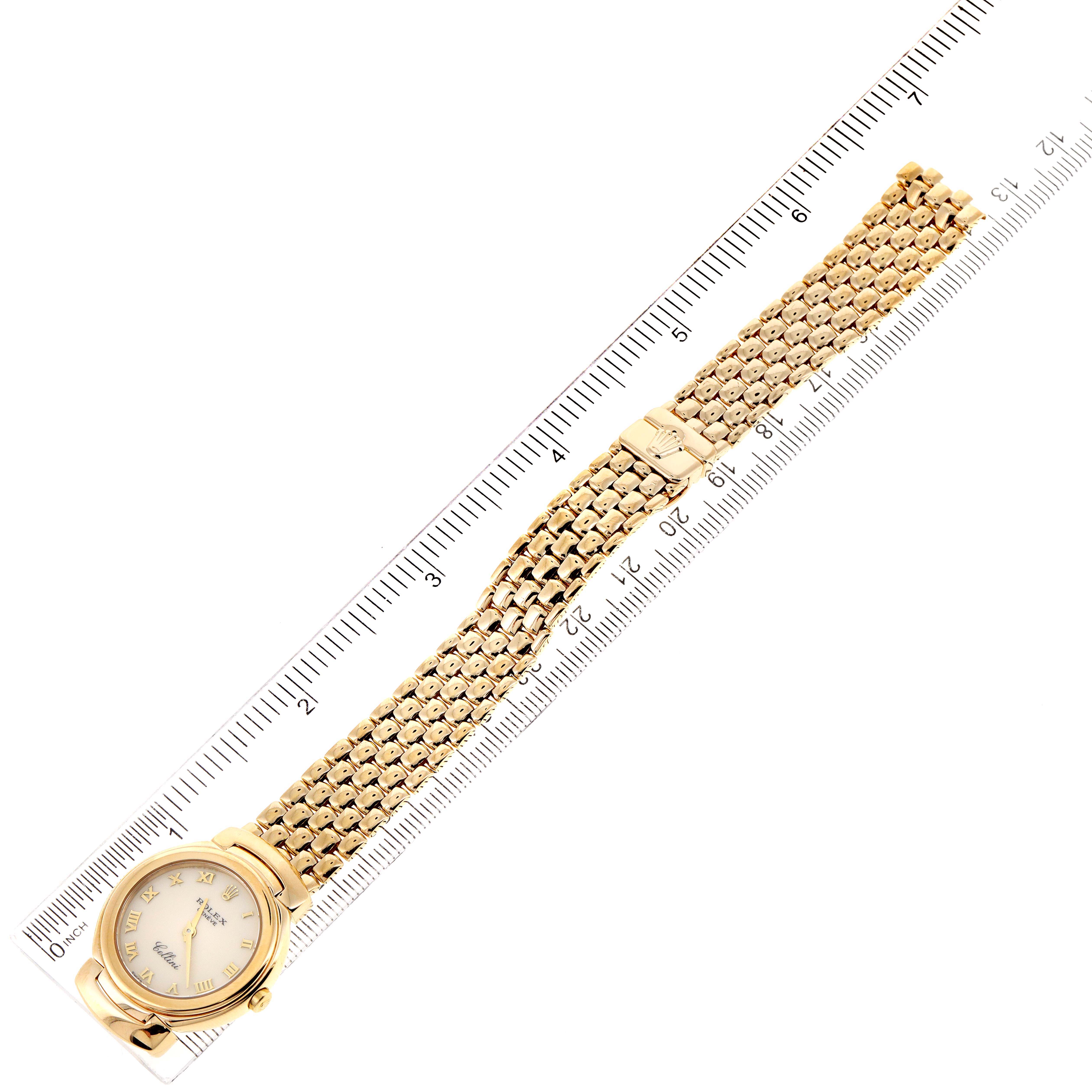 This image shows a Rolex Cellini 6621 Women's Yellow Gold Beige Dial 6621 Women's Yellow Gold Beige Dial watch laid flat with its face and gold bracelet alongside a ruler.