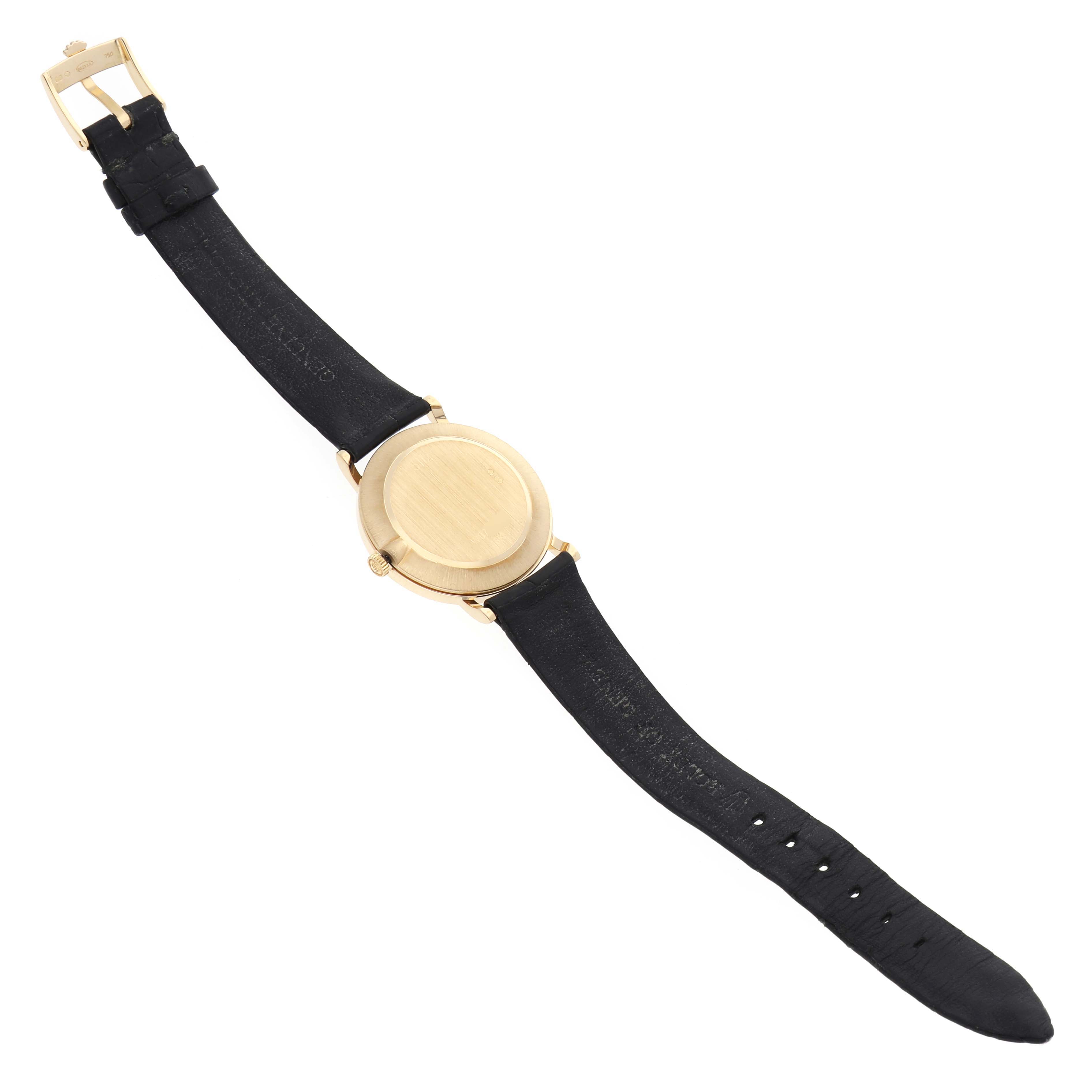 The Rolex Cellini 5112 Men's Yellow Gold White Dial 5112 Men's Yellow Gold White Dial watch is shown from the back, displaying the case back, leather strap, and buckle.