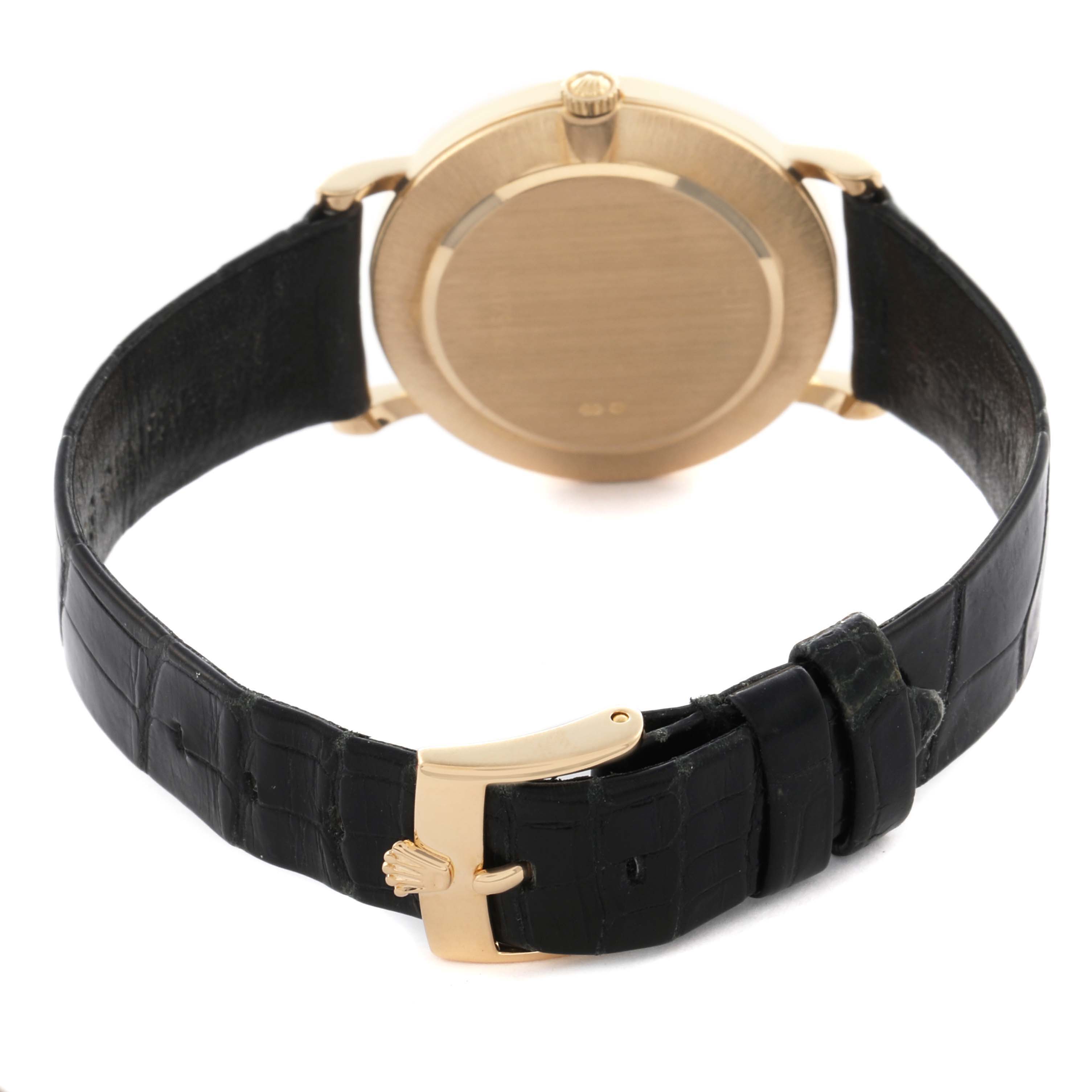 The image shows a rear view of the Rolex Cellini 5112 Men's Yellow Gold White Dial 5112 Men's Yellow Gold White Dial watch, highlighting the case back, crown, and leather strap with a clasp.