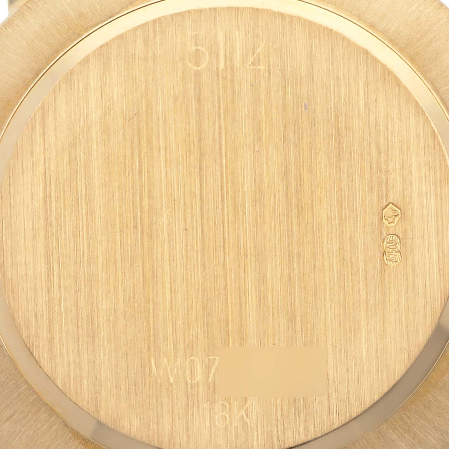 This image shows the back casing of a Rolex Cellini 5112 Men's Yellow Gold White Dial 5112 Men's Yellow Gold White Dial watch, highlighting the engravings and gold texture from a straight angle.