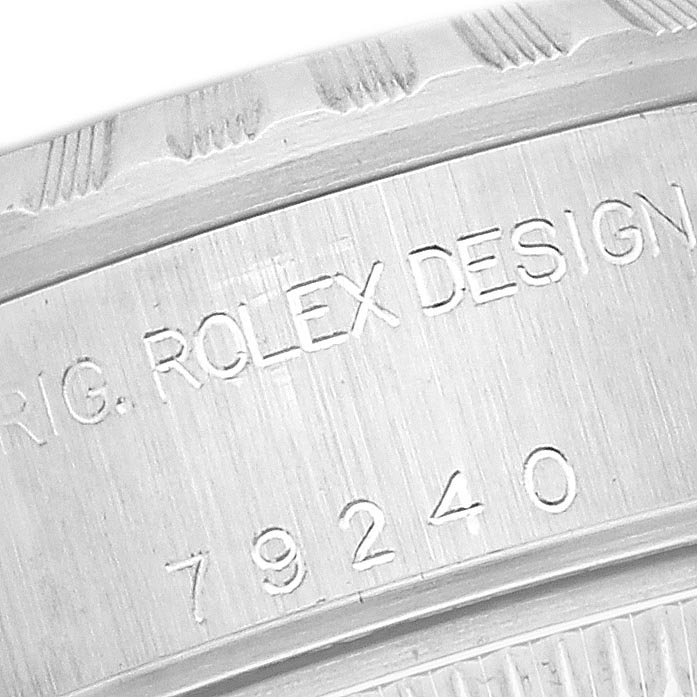 The image shows a close-up of the Rolex Date 79240 Women's Stainless Steel Pink Dial 79240 Women's Stainless Steel Pink Dial watch's case edge, featuring engraved text and model number.