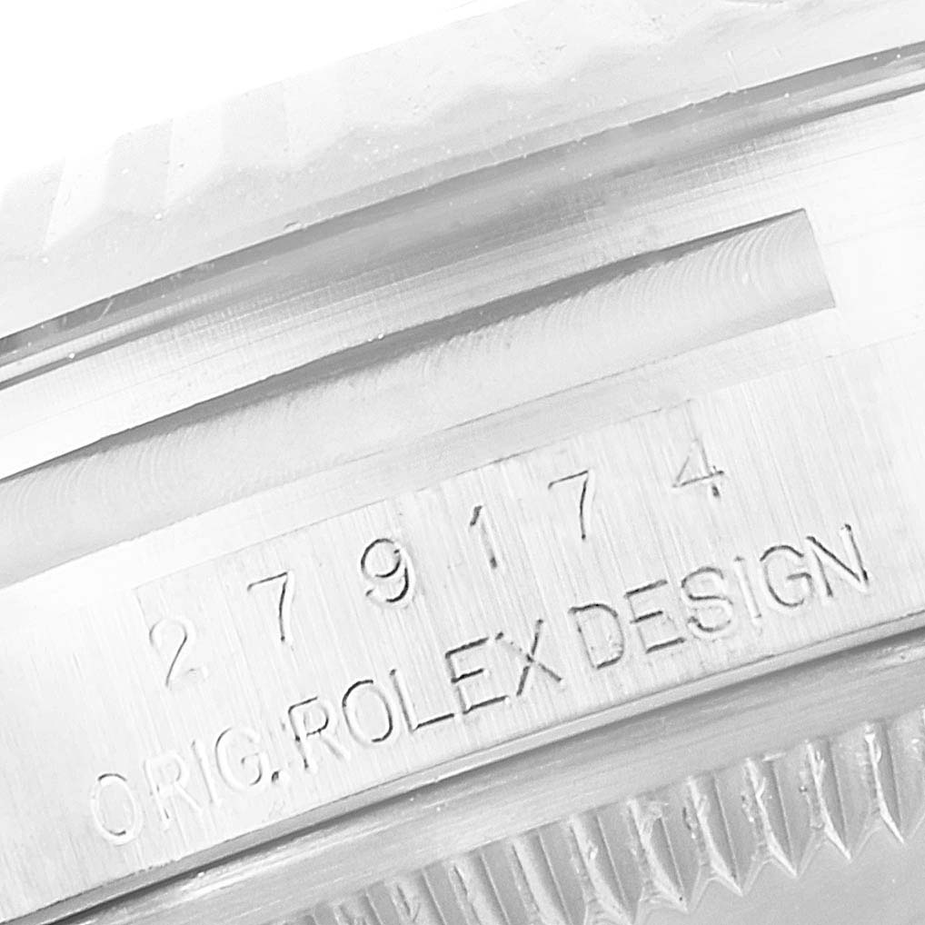 This image shows a close-up of the serial number and "ORIG. ROLEX DESIGN" engraving on the side of a Rolex Datejust 279174 Women's Stainless Steel Mother of Pearl Dial 279174 Women's Stainless Steel Mother of Pearl Dial watch case.