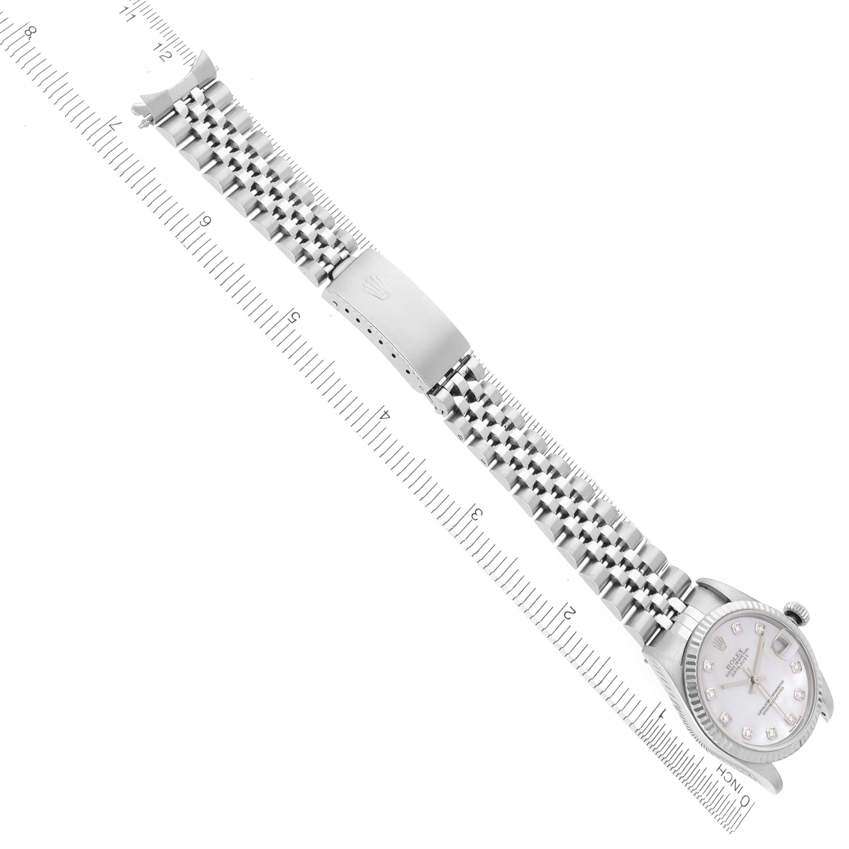 The Rolex Mid-Size 78274 Women's Stainless Steel Mother of Pearl Dial 78274 Women's Stainless Steel Mother of Pearl Dial watch is shown flat with a focus on the bracelet, clasp, and face, alongside a measuring scale.