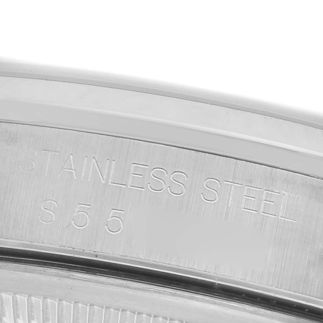 The image shows a close-up of the Rolex Datejust 16200 Men's Stainless Steel Pink Dial 16200 Men's Stainless Steel Pink Dial case back with "STAINLESS STEEL" engraved.