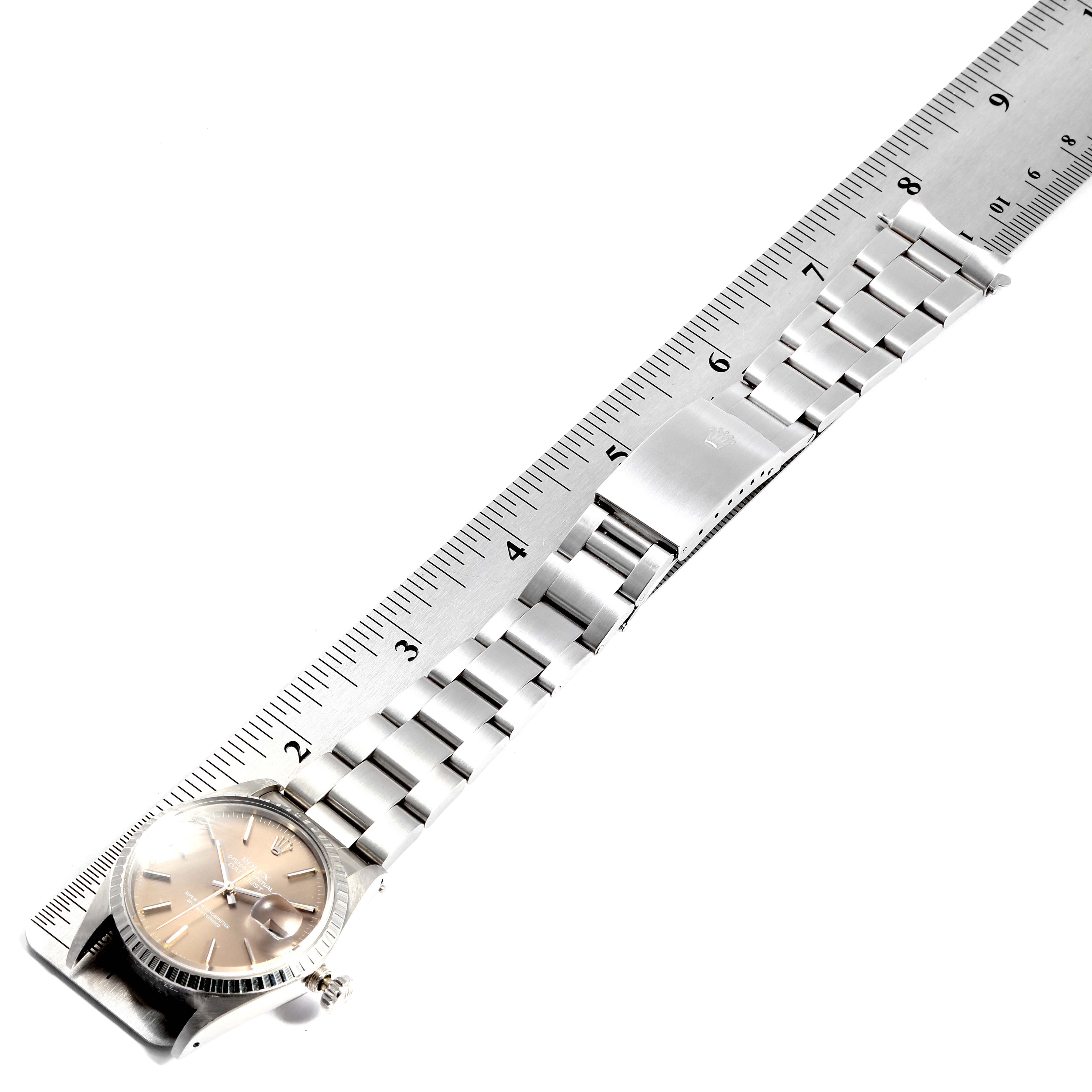The image shows a Rolex Vintage Collection 16030 Men's Stainless Steel Brown Dial 16030 Men's Stainless Steel Brown Dial watch laid flat next to a ruler, displaying its face, bracelet, and clasp.