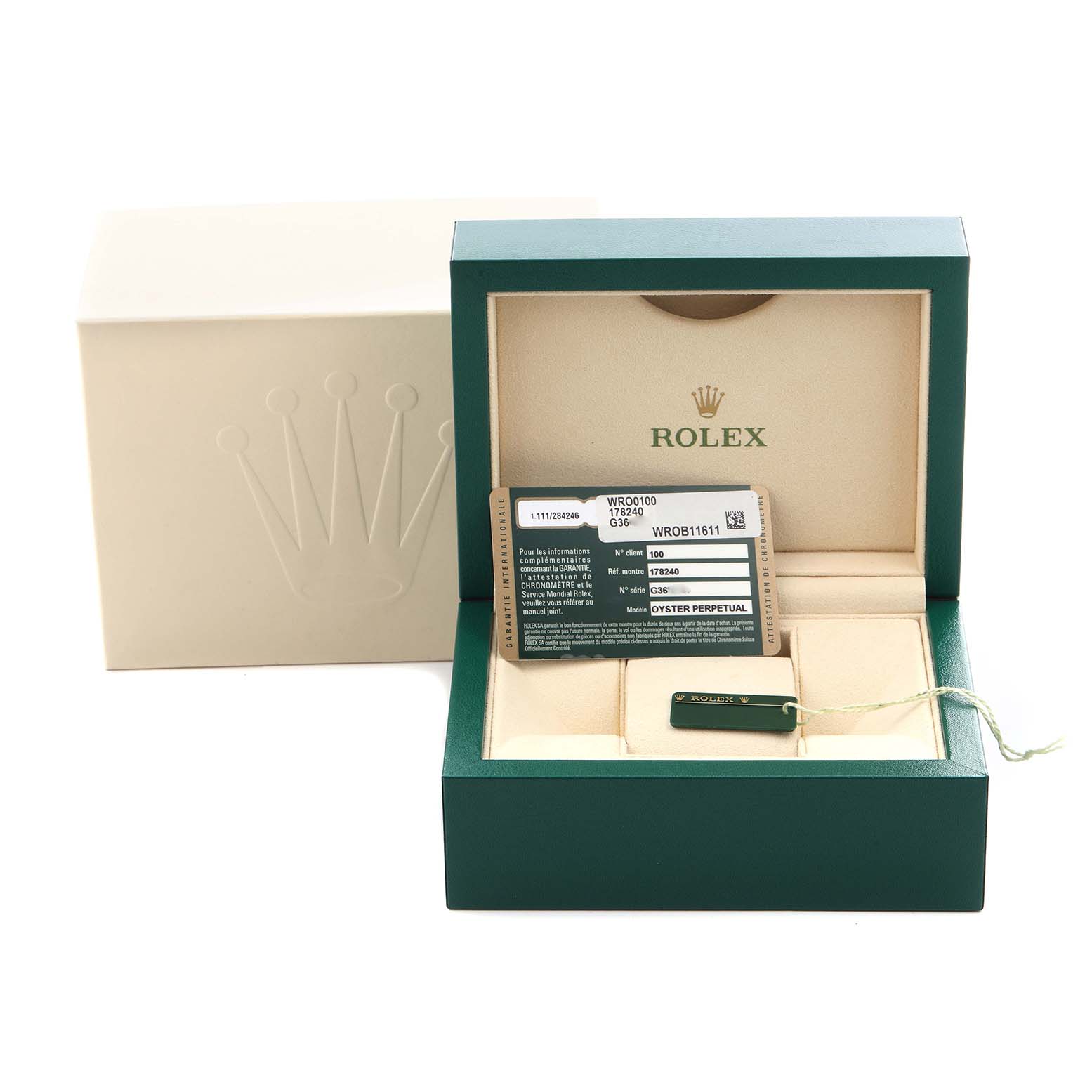 The image shows a Rolex box with a warranty card and tag for a Mid-Size model, viewed from the front.
