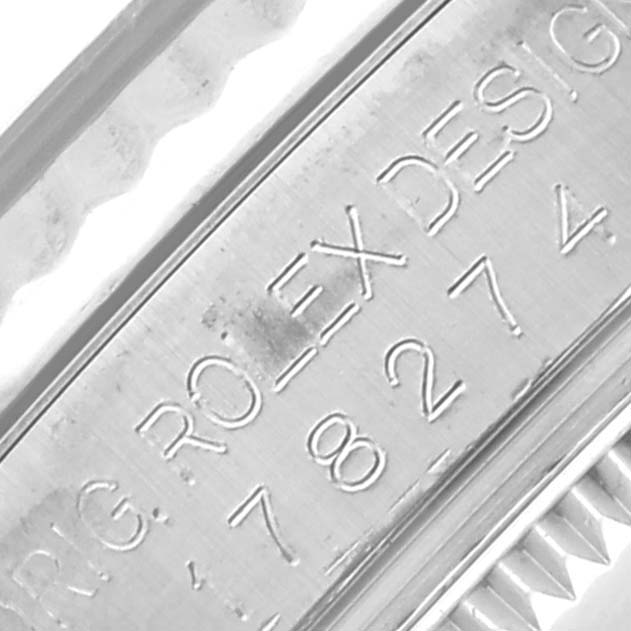 The image shows an angled close-up of a Rolex Mid-Size 178274 Women's Stainless Steel Mother of Pearl Dial 178274 Women's Stainless Steel Mother of Pearl Dial watch, focusing on the engraved inner bezel with the brand name and numbers.