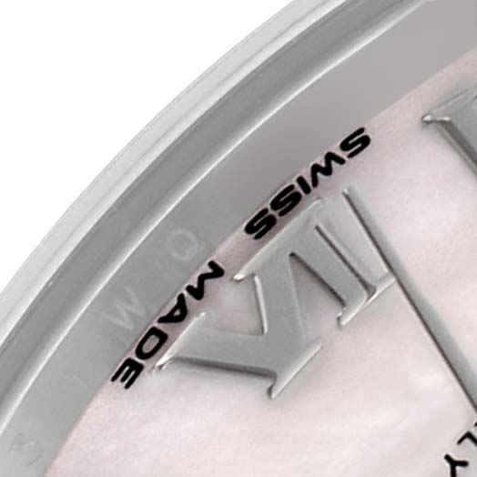 The image shows a close-up of the bezel and dial of a Mid-Size Rolex watch, highlighting the "SWISS MADE" text and Roman numeral XII.