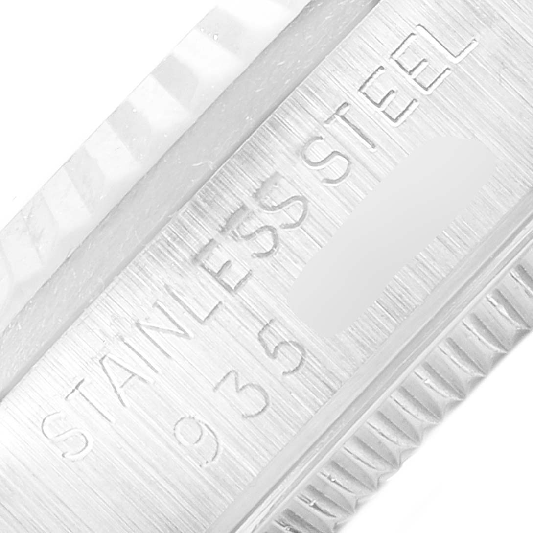 The image shows a macro view of the bezel and case side of a Rolex Mid-Size 68274 Women
s Stainless Steel Silver Dial 68274 Women
s Stainless Steel Silver Dial watch, highlighting the "STAINLESS STEEL" engraving.