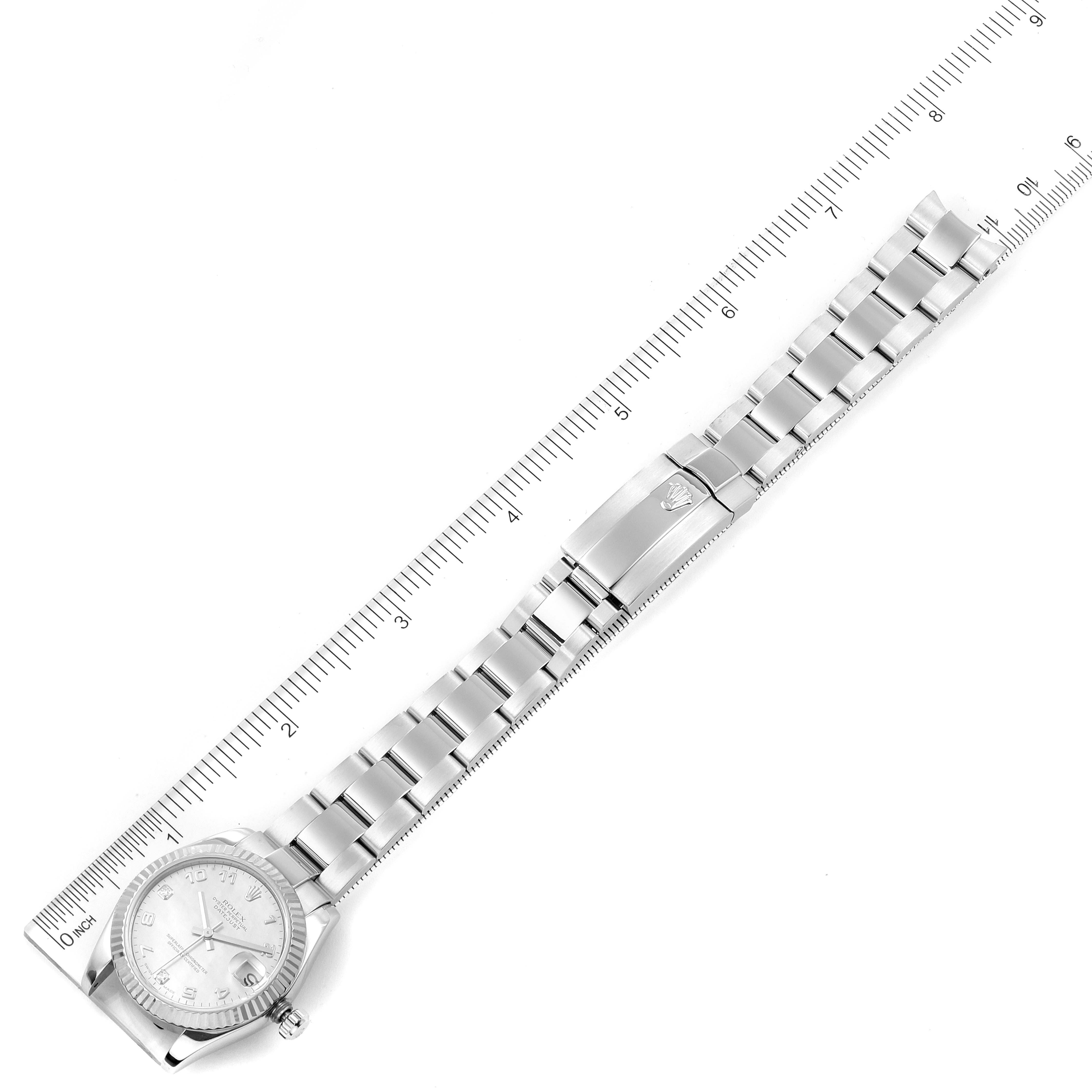 The image shows a top-down view of a Mid-Size Rolex watch with its metal strap fully extended alongside a ruler for scale.