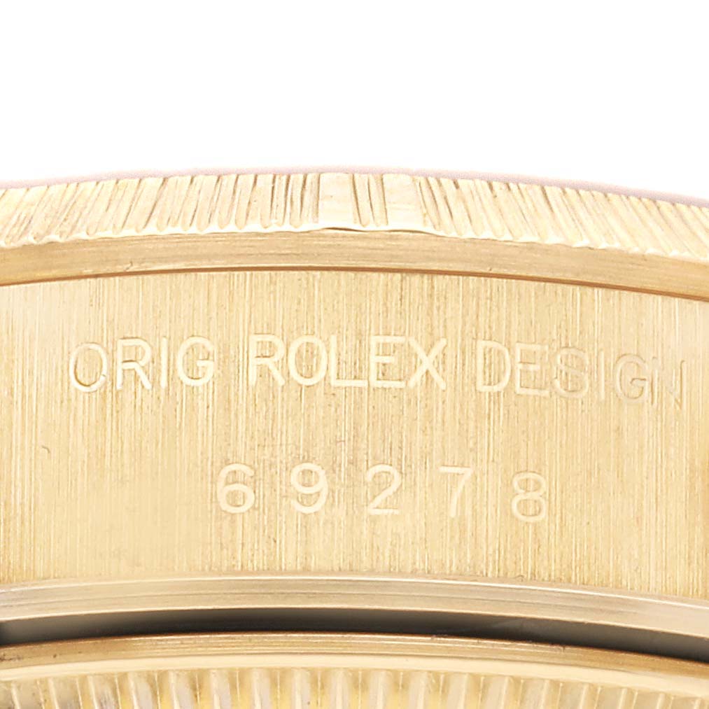 The image shows a close-up of the side engraving and serial number on a Rolex President 69278G Women's Yellow Gold Champagne Dial 69278G Women's Yellow Gold Champagne Dial model watch.