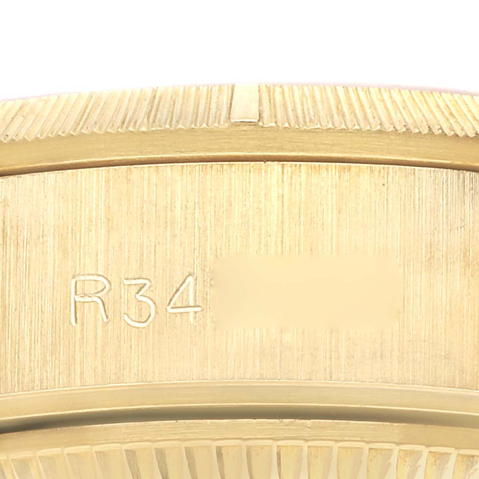 This image shows a close-up of the engraved serial number on the gold casing of a Rolex President 69278 Women's Yellow Gold Champagne Dial 69278 Women's Yellow Gold Champagne Dial model watch.