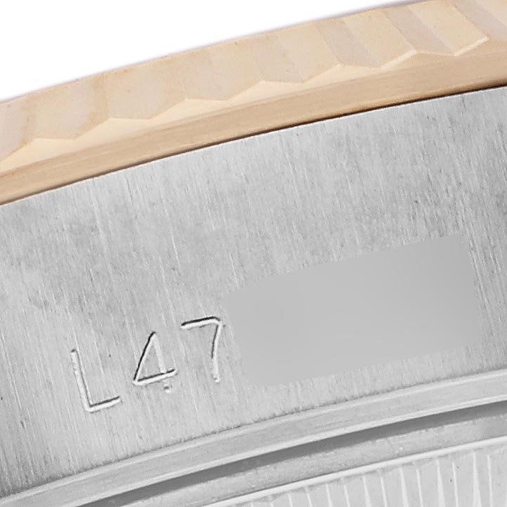 The image shows a close-up of the engraved side of the bezel and case of a Rolex Datejust 69173 Women's Steel and Gold (two tone) Champagne Dial 69173 Women's Steel and Gold (two tone) Champagne Dial watch.