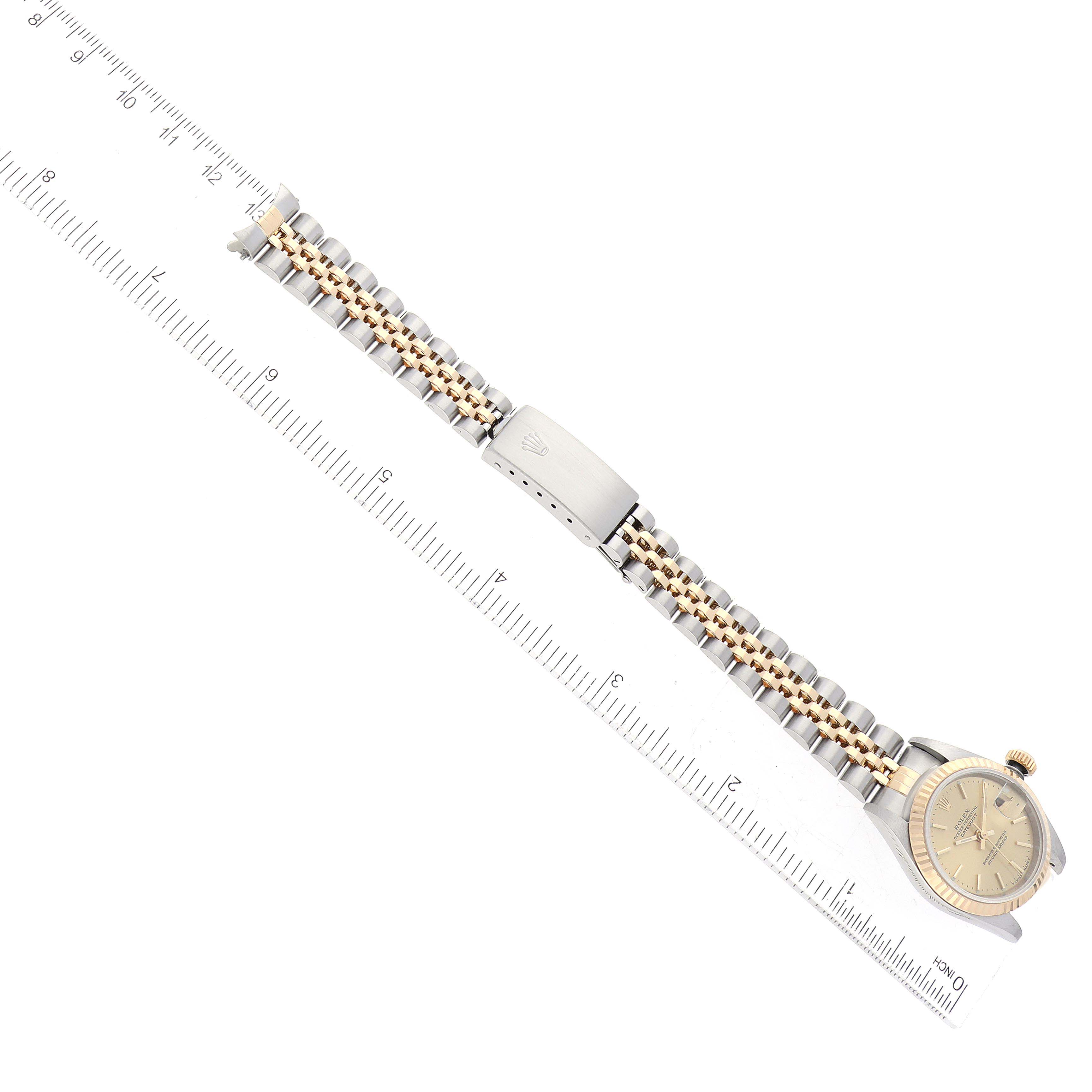 The image shows a Rolex Datejust 79173 Women's Steel and Gold (two tone) Champagne Dial 79173 Women's Steel and Gold (two tone) Champagne Dial watch from top view, highlighting the face, bezel, and metal bracelet with a clasp.