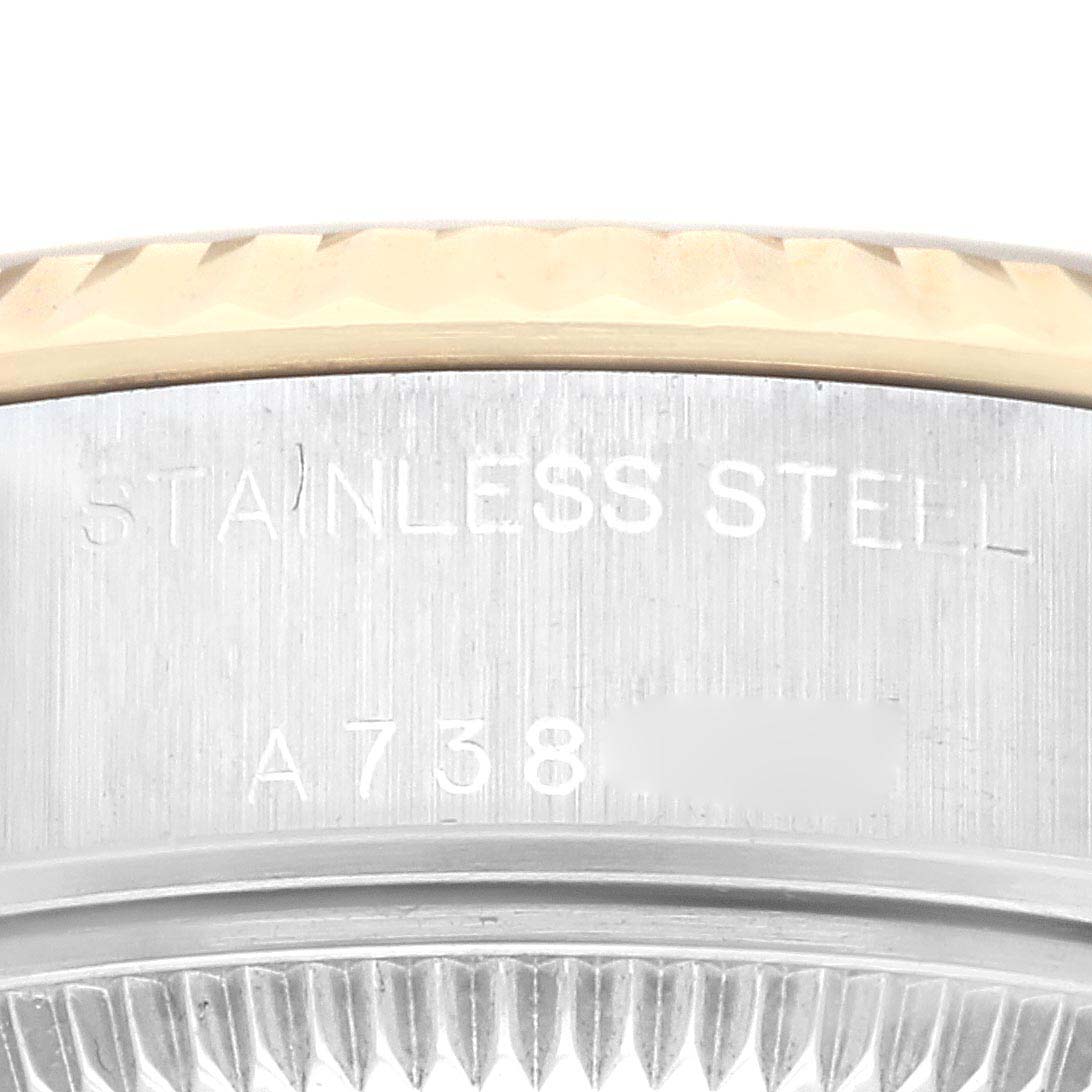 This close-up image shows a portion of the bezel and the "STAINLESS STEEL" engraving on the case of a Rolex Datejust 79173 Women's Steel and Gold (two tone) Champagne Dial 79173 Women's Steel and Gold (two tone) Champagne Dial watch.