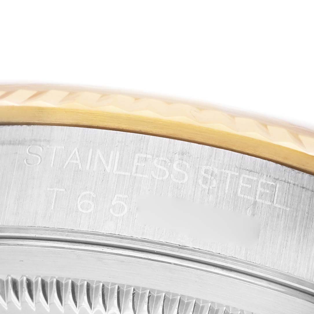 The image shows a close-up of the stainless steel side and fluted bezel of a Rolex Datejust 16233 Men's Stainless Steel Champagne Dial watch.