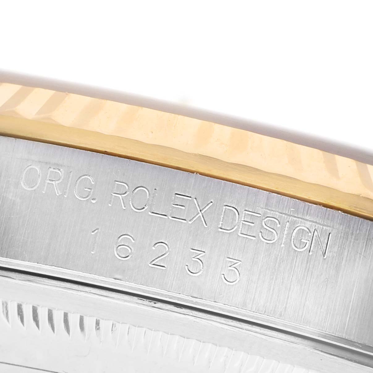 The image shows a close-up of the side of a Rolex Datejust 16233 Men's Stainless Steel Champagne Dial watch, highlighting the engraved model number and fluted bezel.