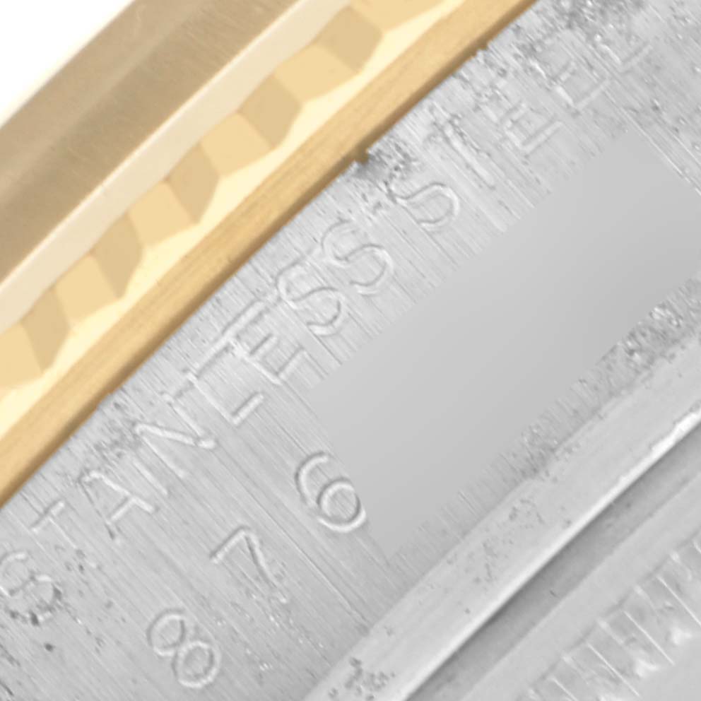 The image shows a close-up of the side and edge of the bezel and case with engravings on a Rolex Datejust 16013 Men's Steel and Gold (two tone) Champagne Dial 16013 Men's Steel and Gold (two tone) Champagne Dial watch.