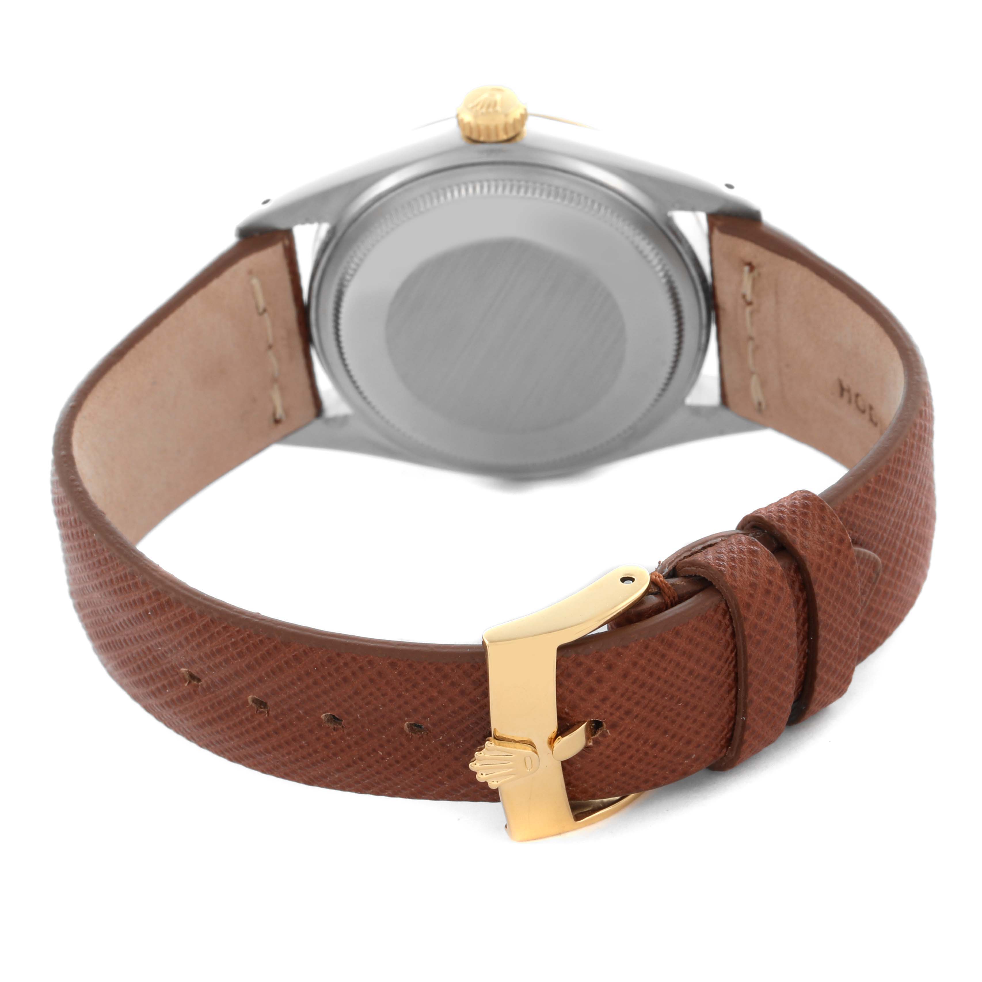 The image shows the back of a Rolex Datejust 16013 Men's Steel and Gold (two tone) Champagne Dial 16013 Men's Steel and Gold (two tone) Champagne Dial watch with a brown leather strap and gold buckle clasp.
