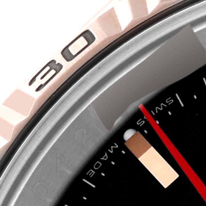 The image shows a close-up of the bezel and dial of the Rolex Turn-o-Graph 116261 Men's Steel and Gold (two tone) Black Dial 116261 Men's Steel and Gold (two tone) Black Dial watch, focusing on the 30-minute marking and part of the minute hand.