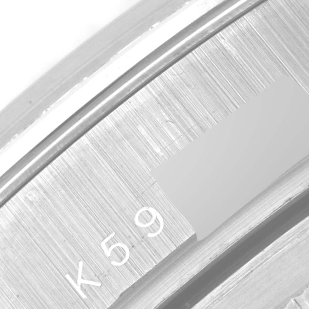 This is a close-up image of the engraved serial number on the case back edge of a Rolex Pearlmaster 18946 Men's Platinum Mother of Pearl Dial 18946 Men's Platinum Mother of Pearl Dial watch.