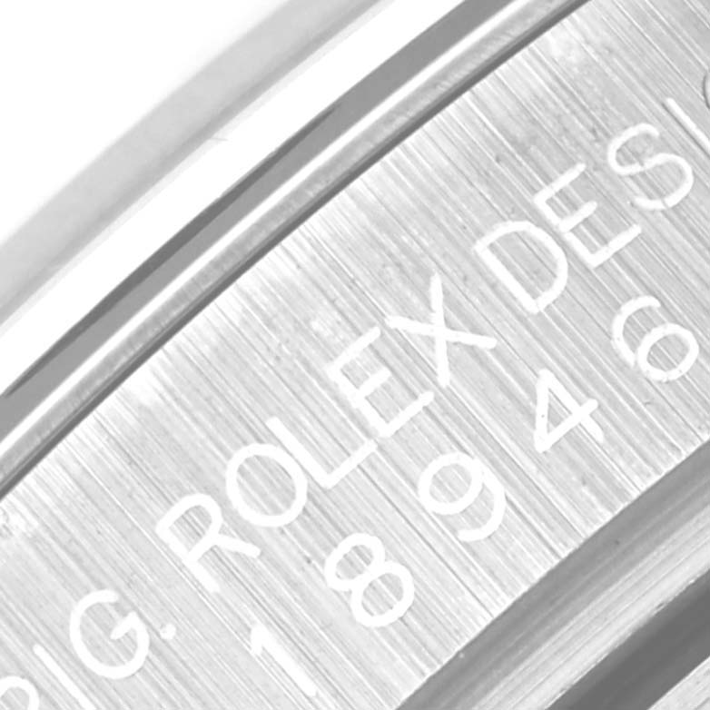 The image shows a close-up of the side of a Rolex Pearlmaster 18946 Men's Platinum Mother of Pearl Dial 18946 Men's Platinum Mother of Pearl Dial watch, focusing on its engraved serial number and brand name.