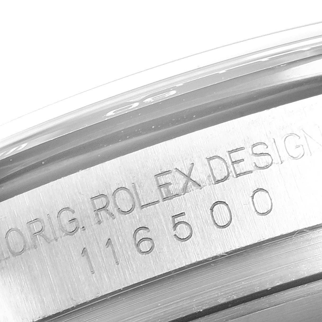 The image shows a close-up of the engraved edge of the case body of a Rolex Daytona 116500 Men's Stainless Steel White Dial 116500 Men's Stainless Steel White Dial watch.