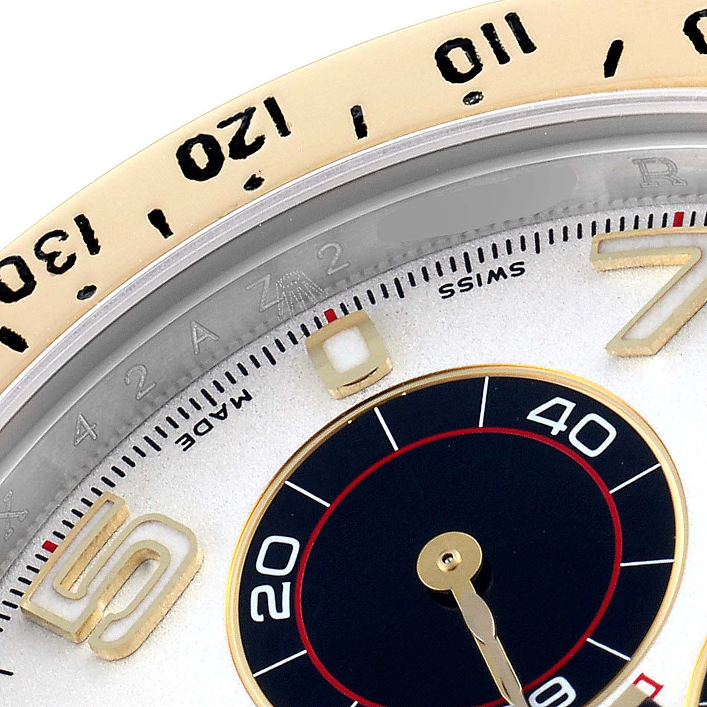 This image shows a close-up of a Rolex Daytona 116523 Men's Steel and Gold (two tone) Silver Dial 116523 Men's Steel and Gold (two tone) Silver Dial watch, focusing on the bezel, minute markers, and a subdial.