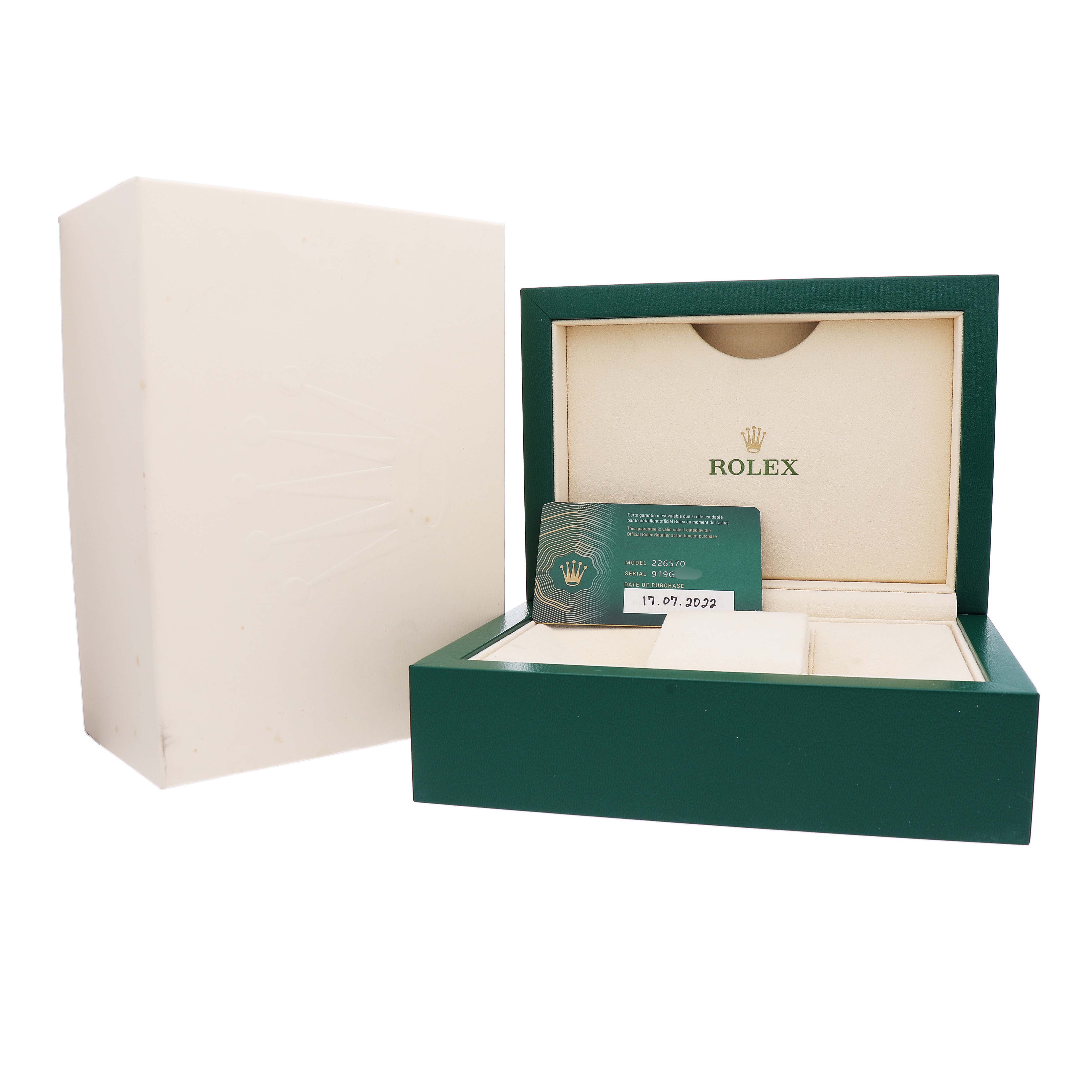 The image shows an open green Rolex box for the Explorer model with a warranty card.