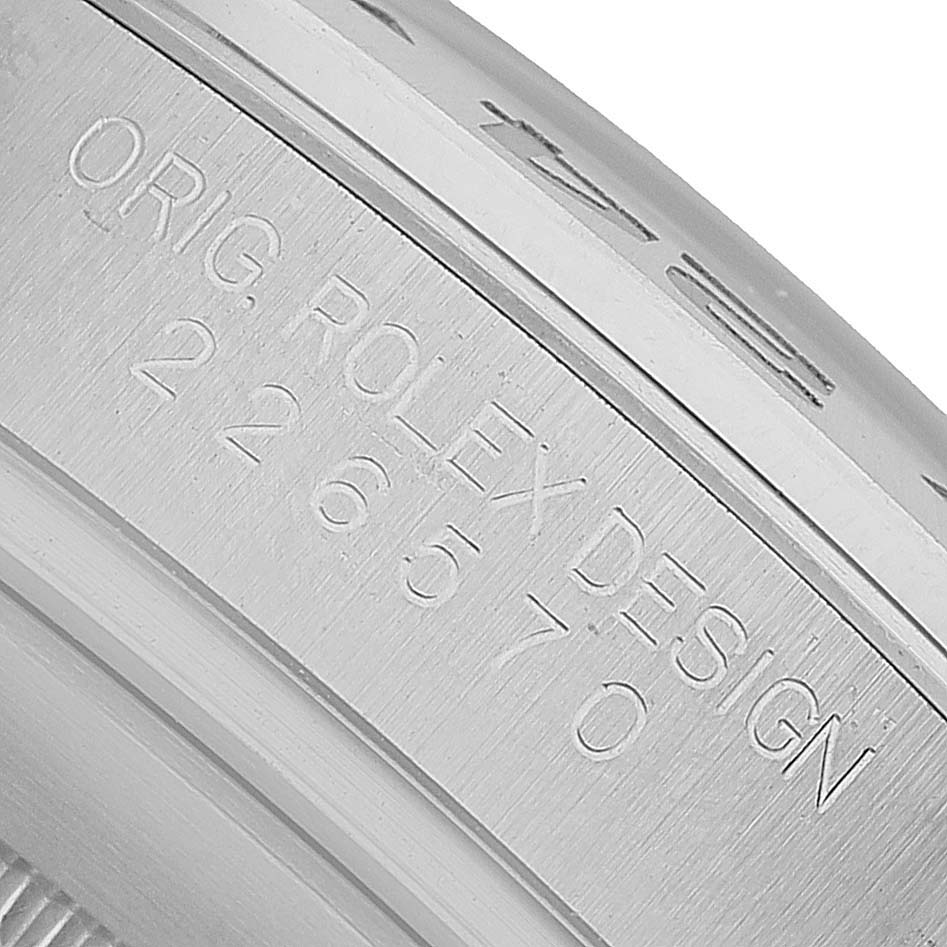 The image shows a close-up of the engraving on the side of a Rolex Explorer M226570-002 Men's Stainless Steel Black Dial watch case.