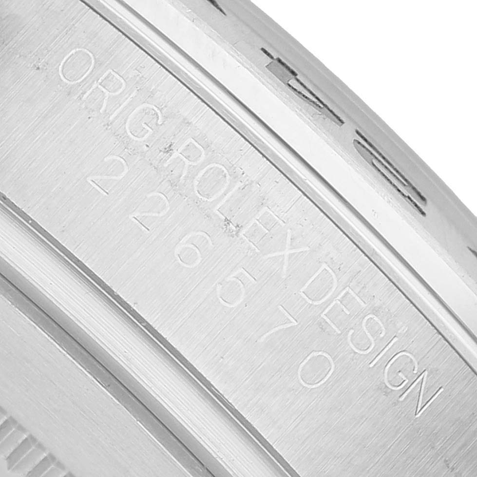 The image shows a close-up of the side engravings on the case of a Rolex Explorer M226570-001 Men's Stainless Steel White Dial watch.