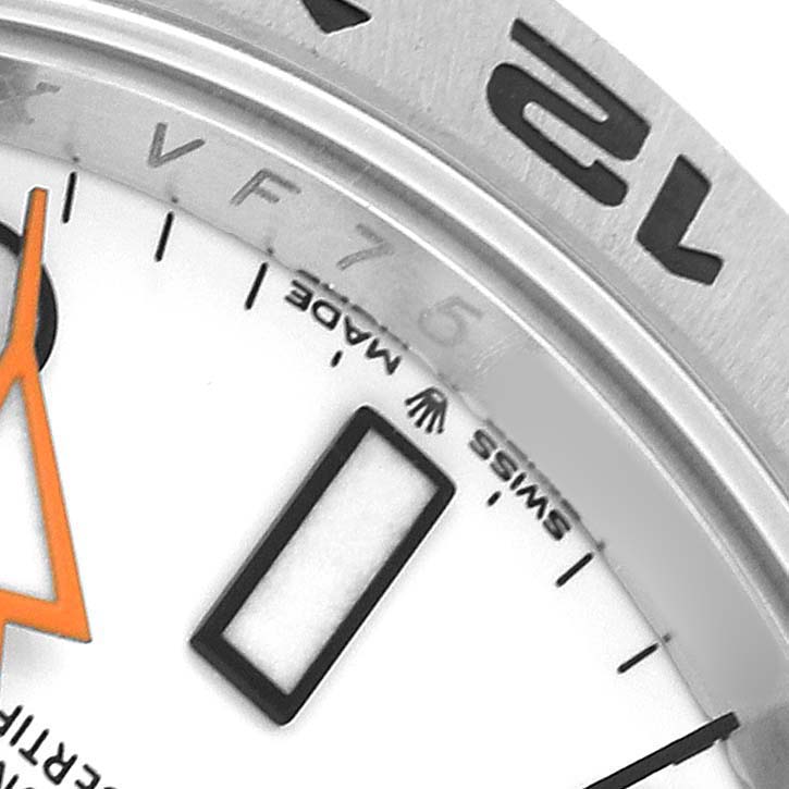 This close-up image of the Rolex Explorer M226570-001 Men's Stainless Steel White Dial shows part of the dial and the bezel with numerals, focusing on hour markers and text details.