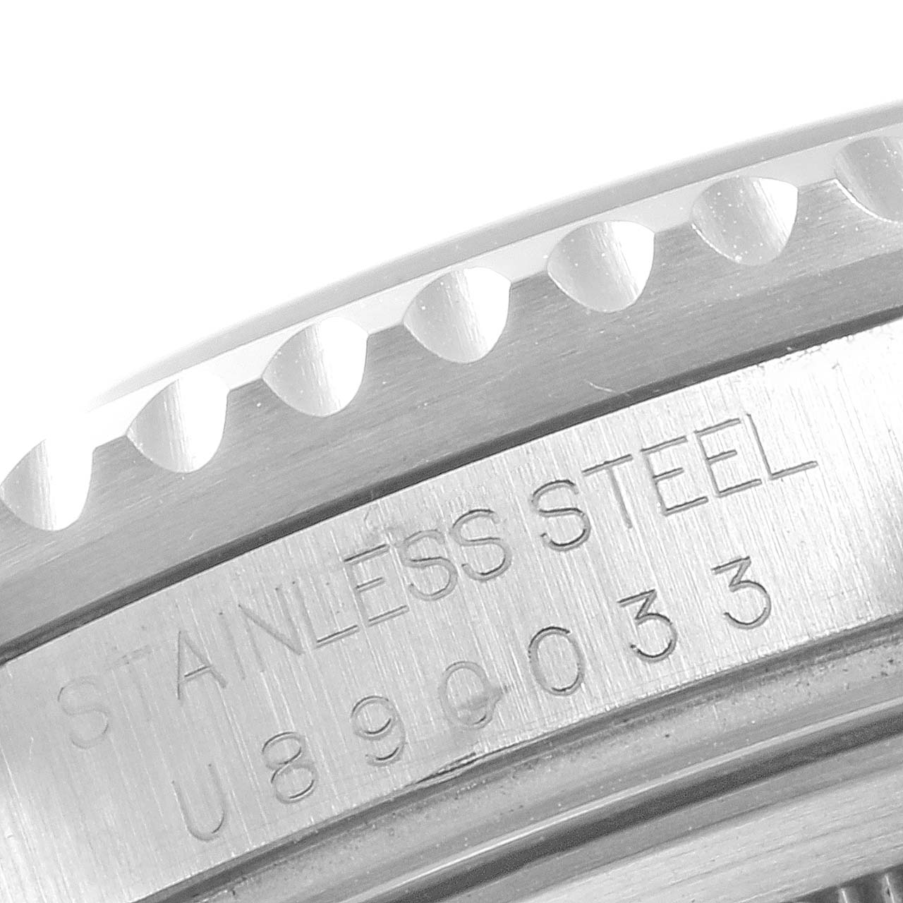 The image shows a close-up of the case back edge and part of the bezel of a Rolex GMT-Master 16710 Men
s Stainless Steel Black Dial 16710 Men
s Stainless Steel Black Dial with 
Stainless Steel
 engraved.