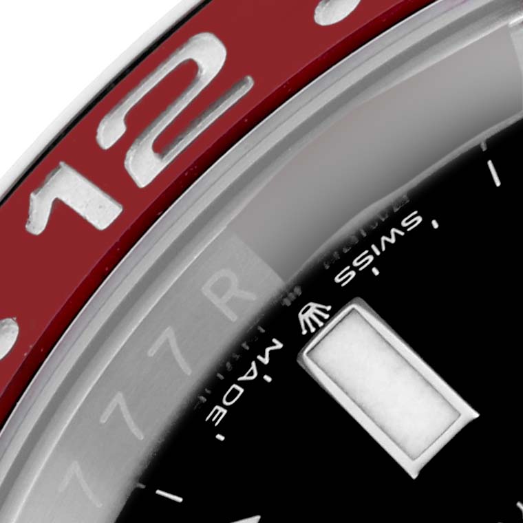 The image shows a close-up of a Rolex GMT-Master 126710BLRO Men's Stainless Steel Black Dial 126710BLRO Men's Stainless Steel Black Dial watch, focusing on the red bezel with the "12" and part of the dial with the brand logo.