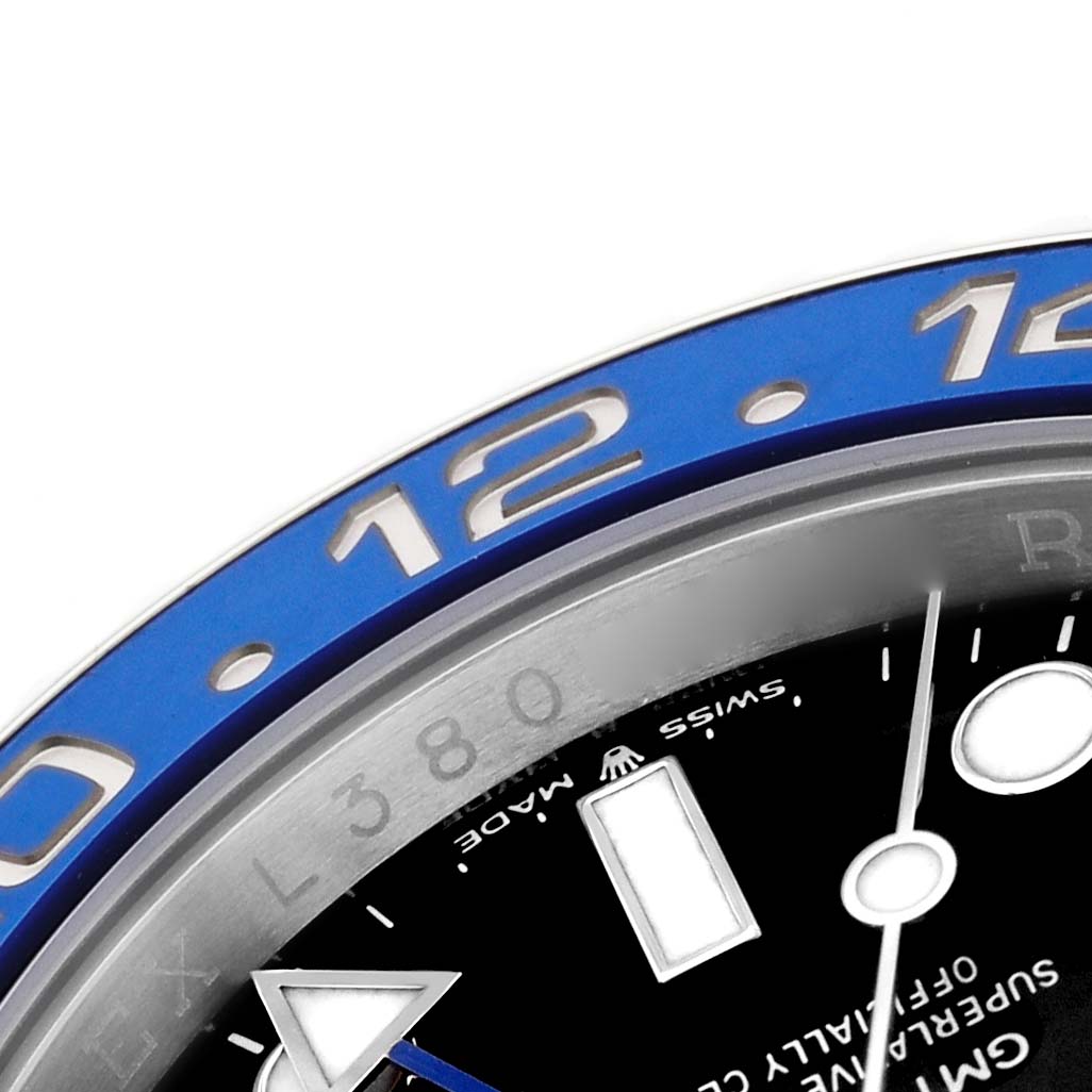 The image shows a close-up of the blue bezel and part of the dial of a Rolex GMT-Master 126710BLNR Men's Stainless Steel Black Dial watch, highlighting the 12 o'clock marker.