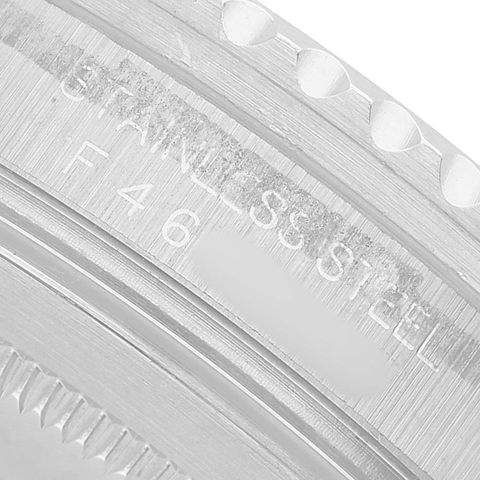 The image shows a close-up of the stainless steel case and engraved markings on the side of a Rolex GMT-Master 16710 Men's Stainless Steel Black Dial watch.