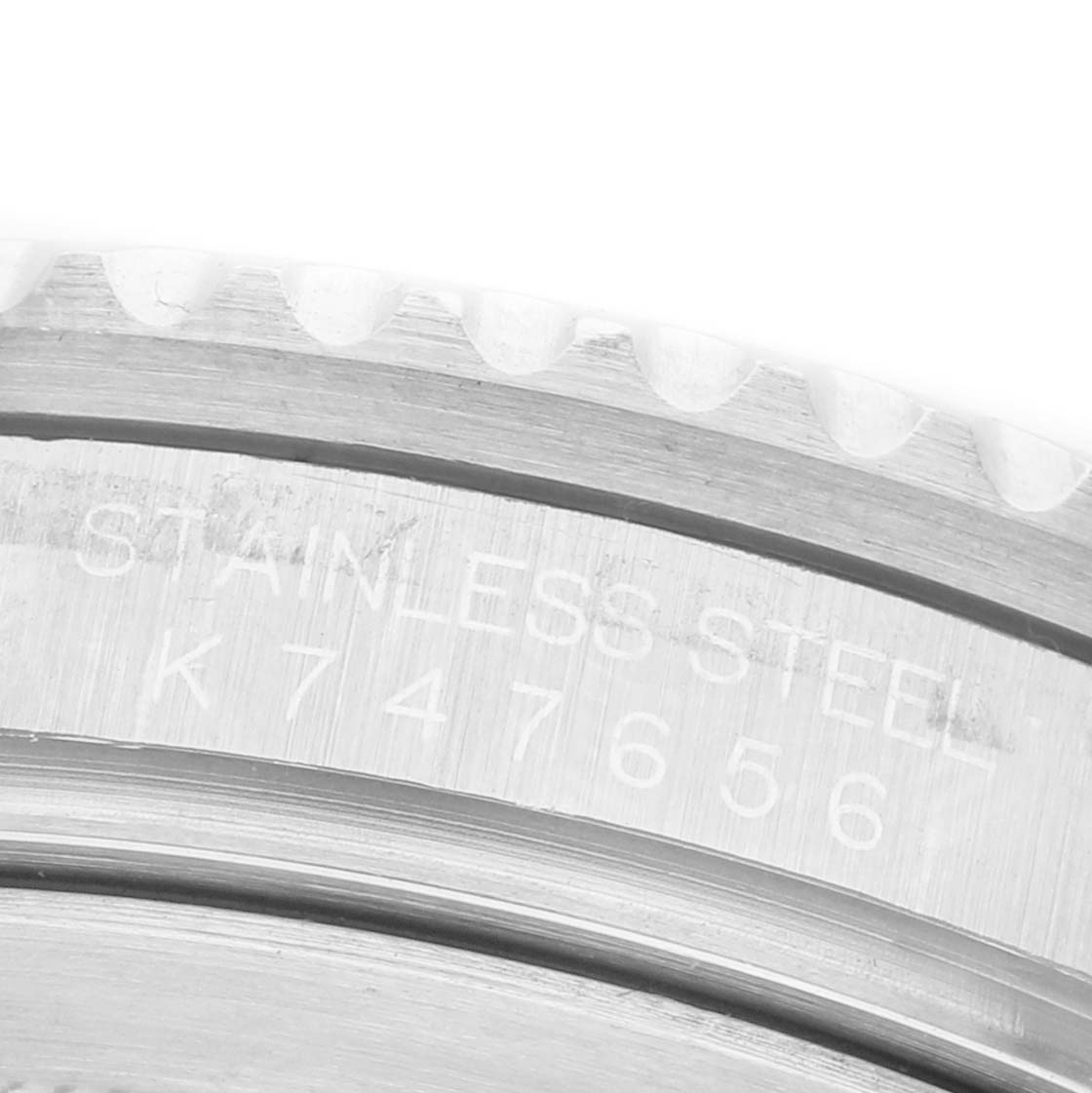 The image shows a close-up of the Rolex GMT-Master 16710 Men's Stainless Steel Black Dial's side, highlighting the serial number engraved on the stainless steel case.