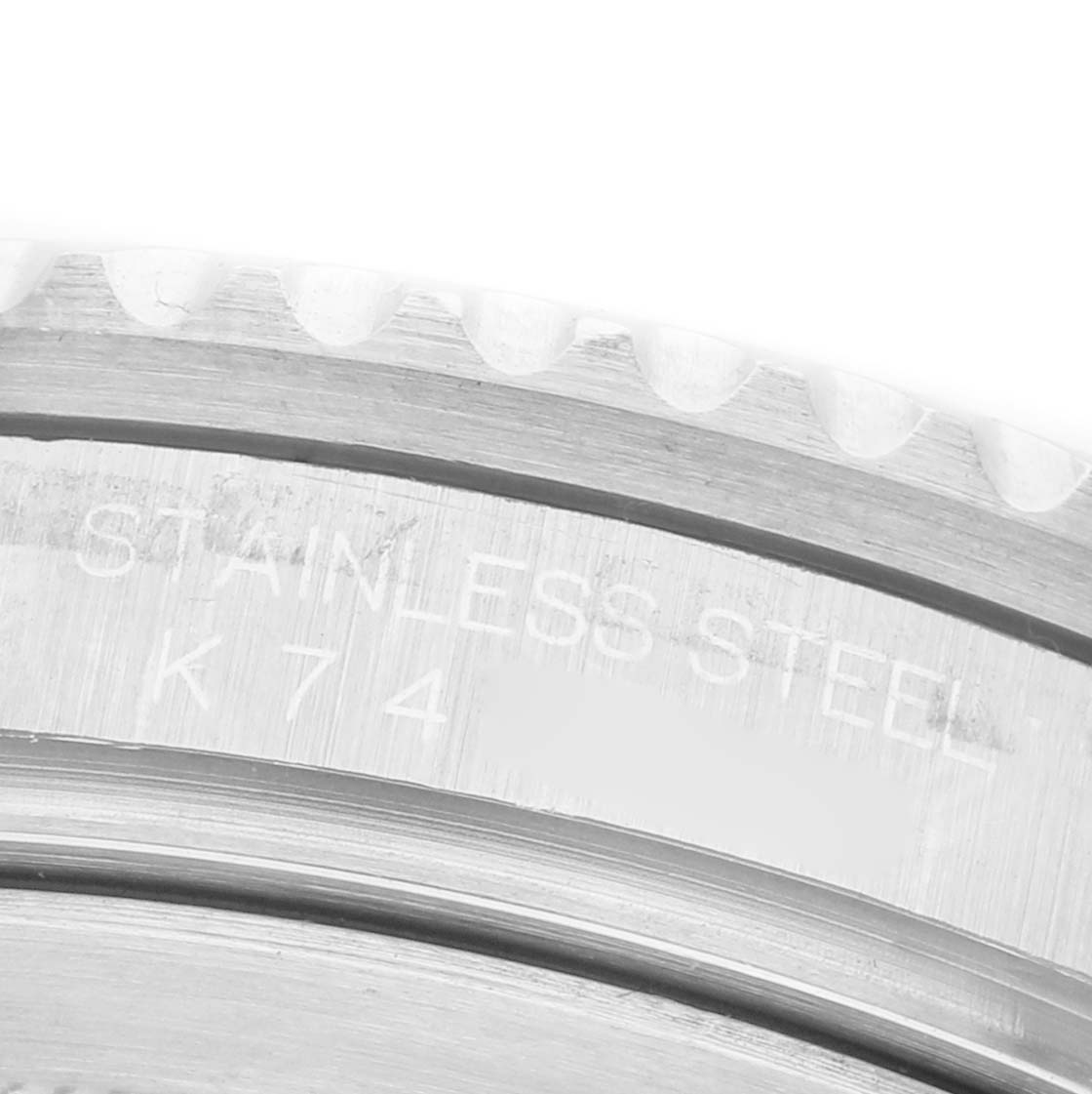 The image shows a close-up of the outer edge and engraved text on the bezel of a Rolex GMT-Master 16710 Men's Stainless Steel Black Dial watch.