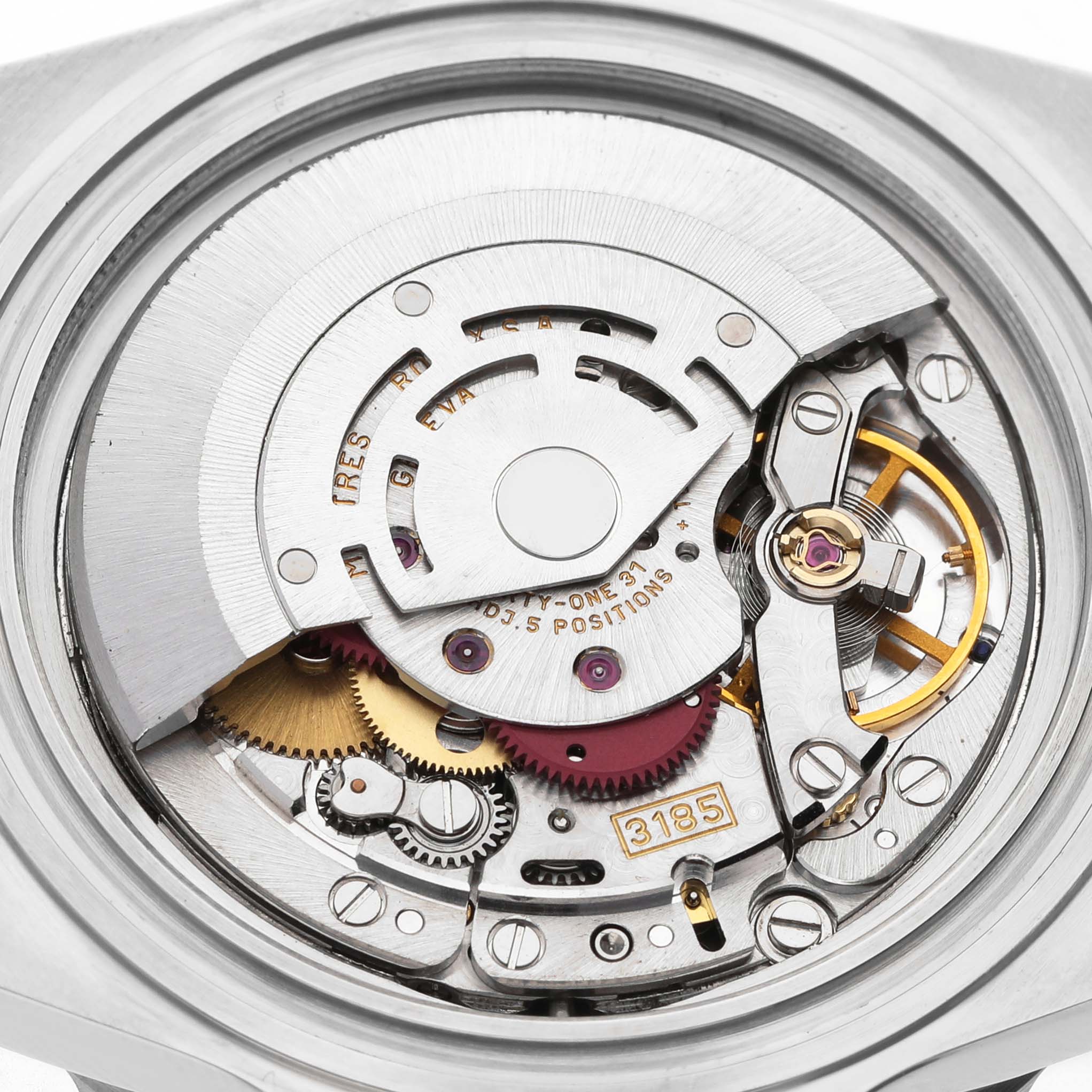 The image shows the intricate internal movement of a Rolex GMT-Master 16710 Men's Stainless Steel Black Dial watch, including gears and the rotor.